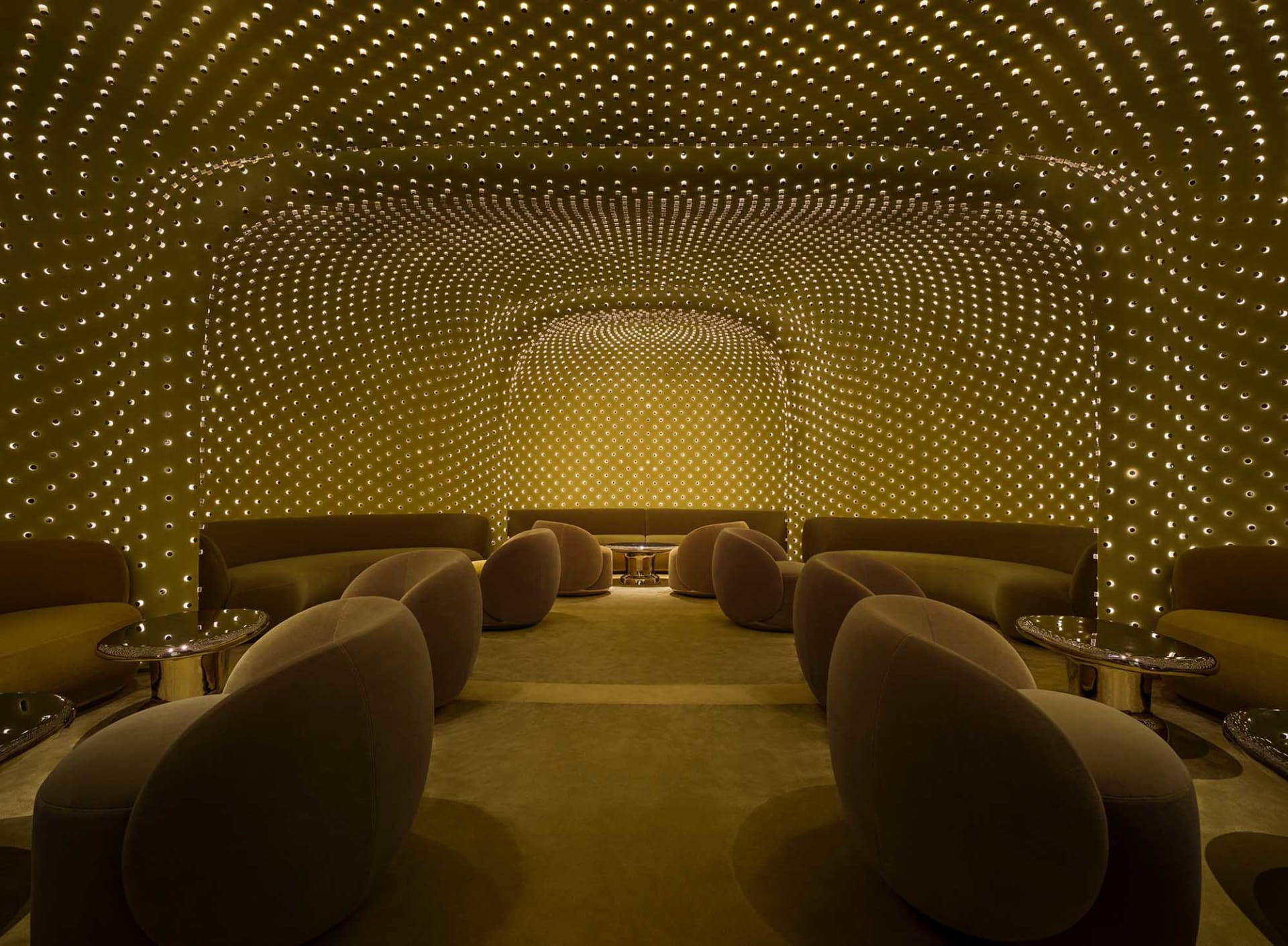 A warm and inviting room with a yellow ceiling and walls, featuring various seating options and a comfortable atmosphere
