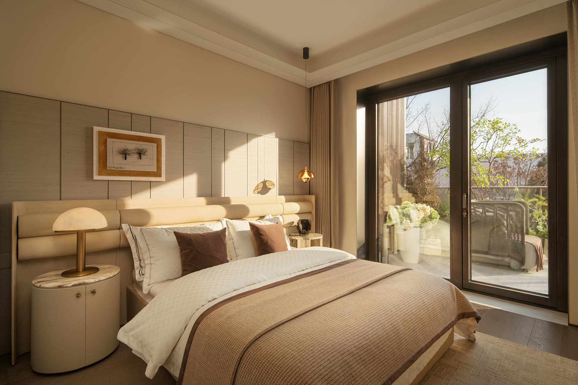 Cozy bedroom with a brown blanket-covered bed, a chair near the window, and natural light from the window
