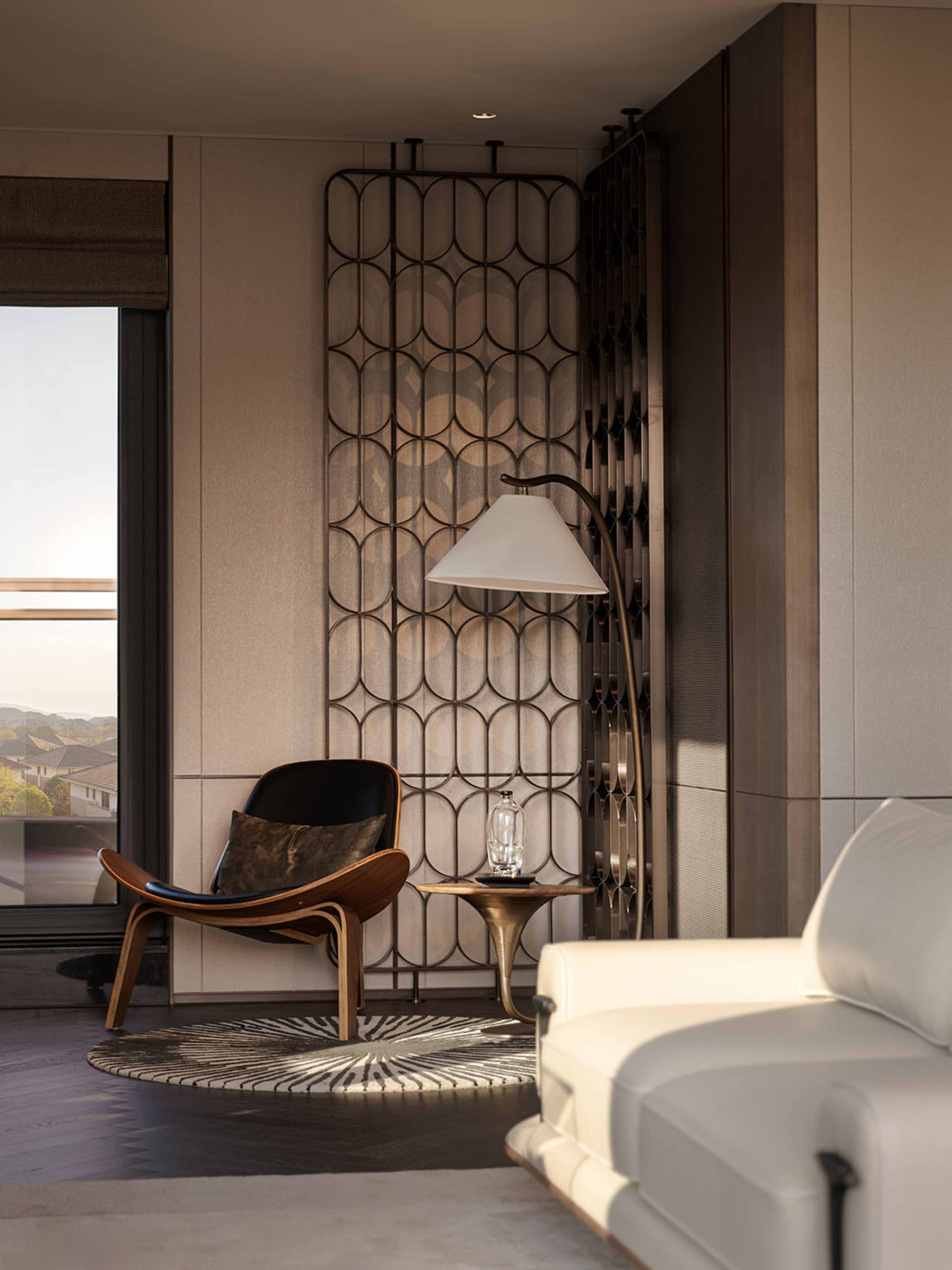 Cozy living room with a white couch and chair, a patterned wall, and a window with a view of the outdoors