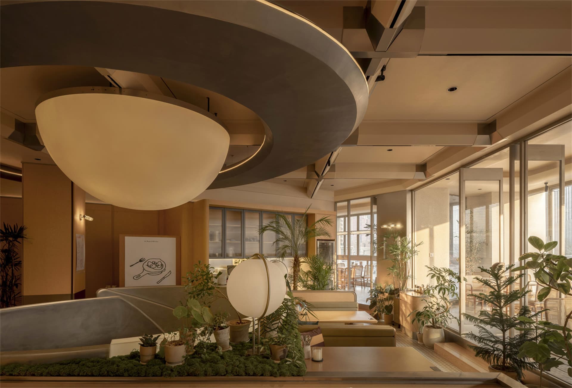 Cozy living room with a circular light fixture, a couch, dining table, and potted plants, featuring soft and warm lighting