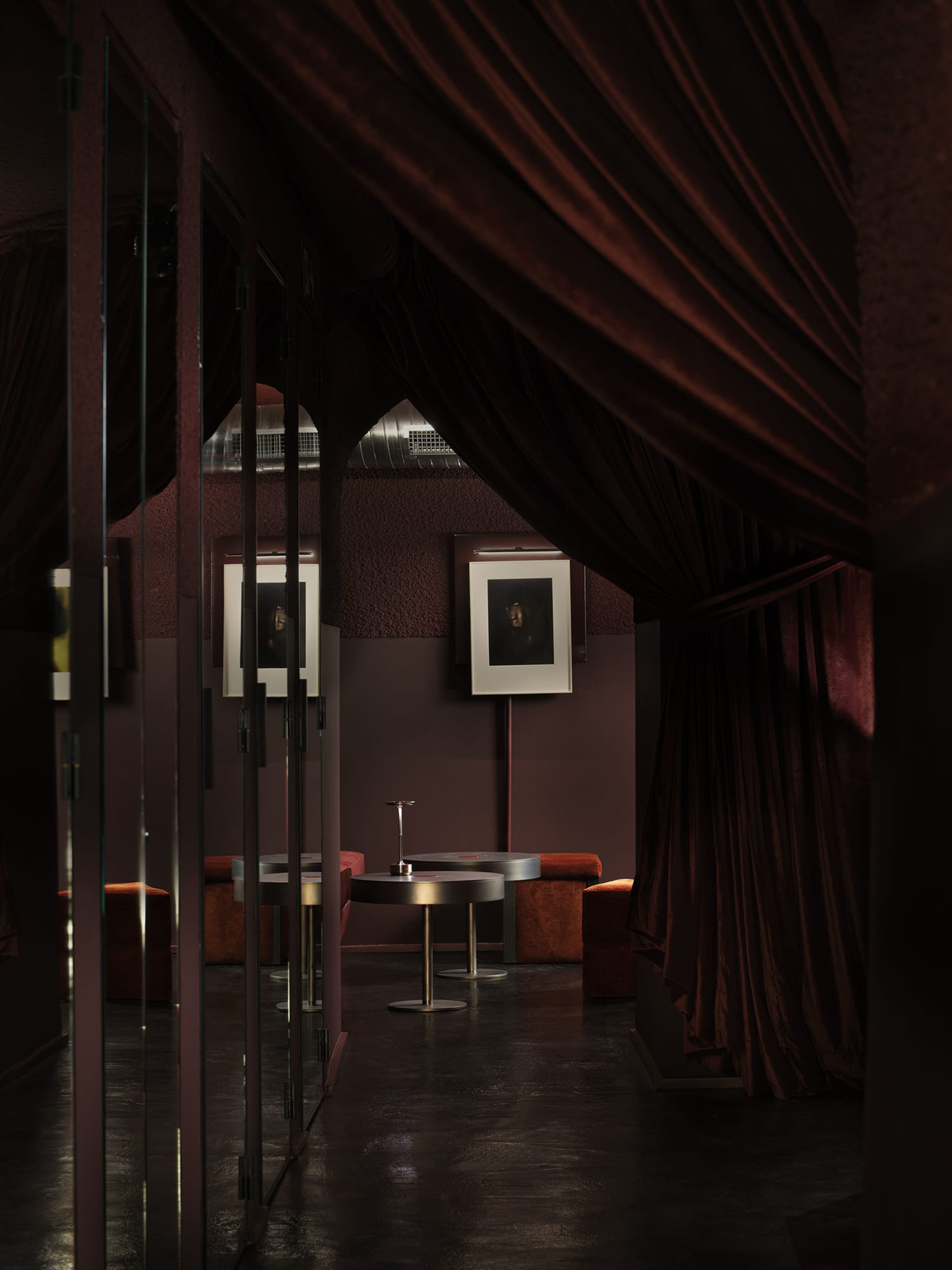 Dining area with a curtained doorway, a dining table, and a chair, featuring a modern style with high-quality materials and neutral colors