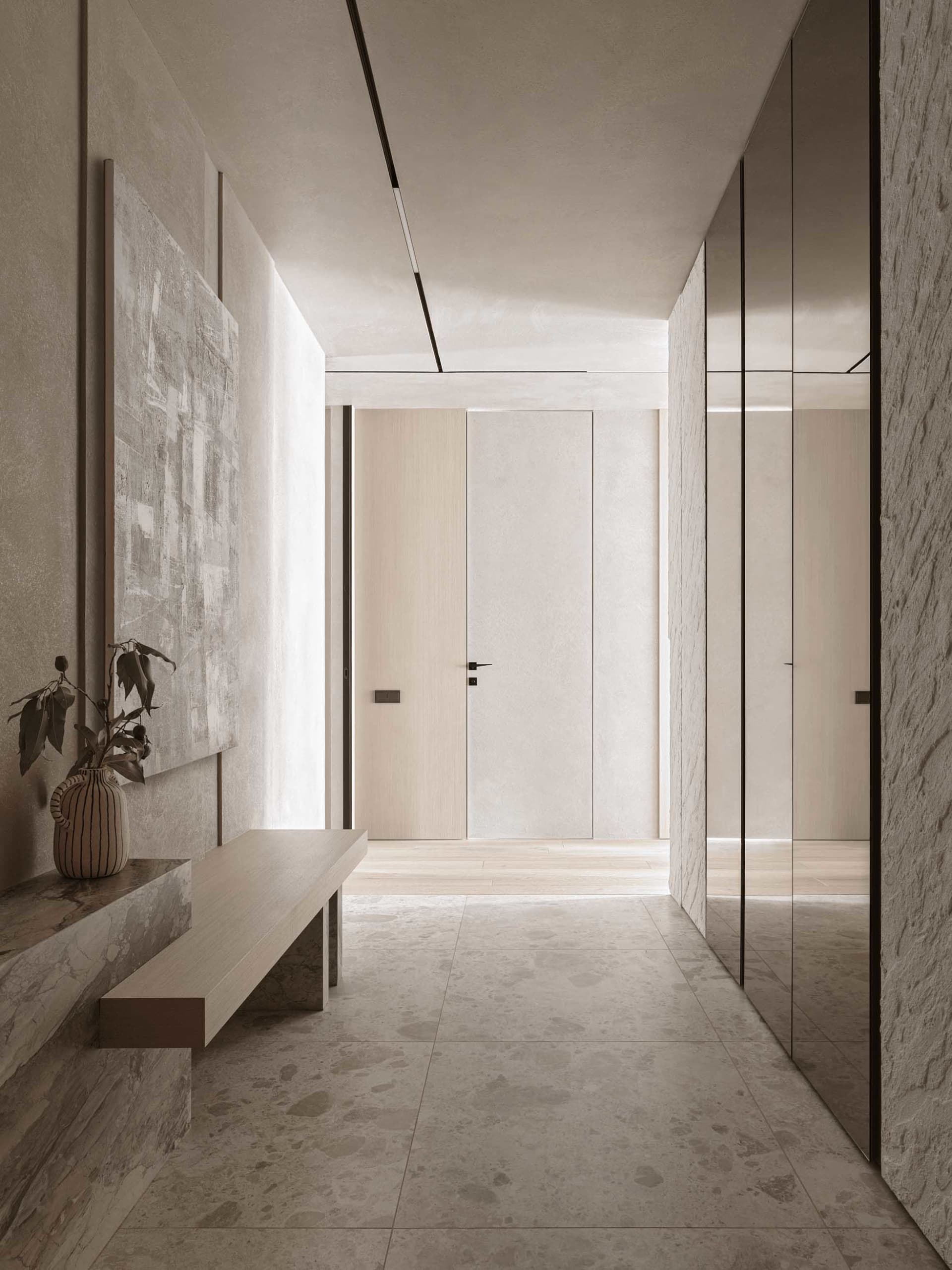 A well-lit modern hallway with a white color scheme, wood accents, and comfortable seating area with a bench