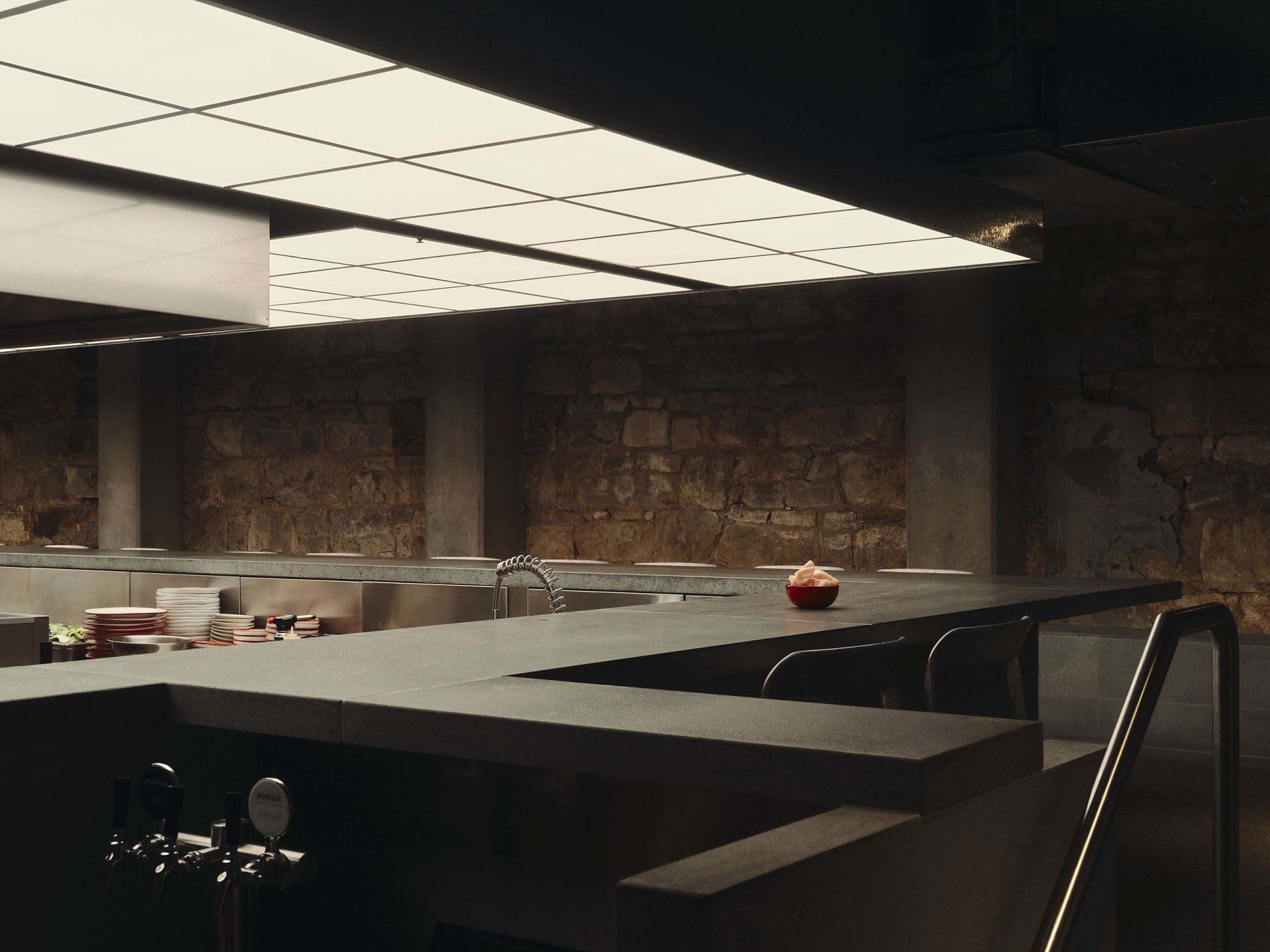 Cozy kitchen with a stone countertop, sink, and dim lighting