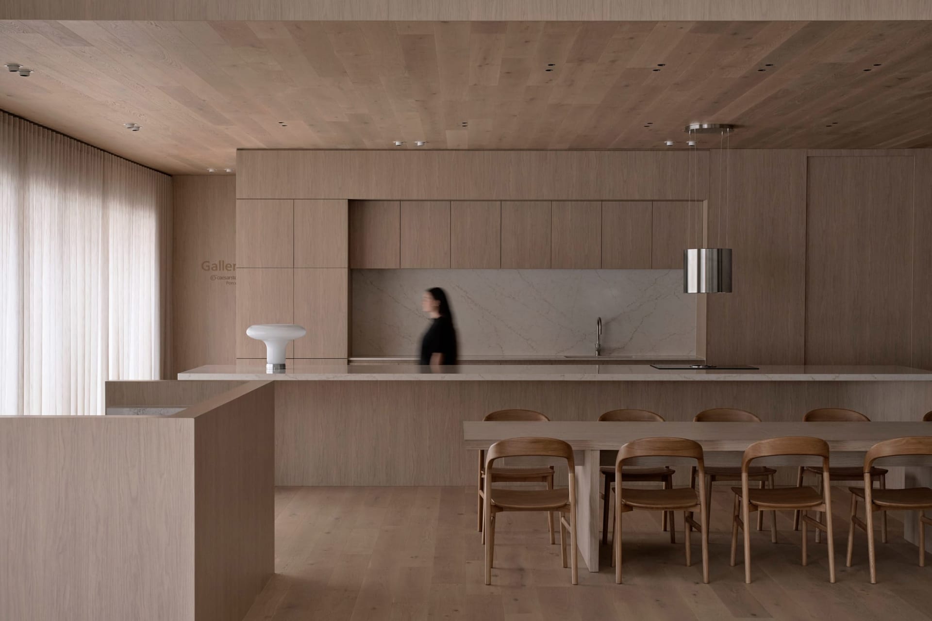 Warm and inviting kitchen with wooden floors and cabinets, a dining table, and soft diffused lighting