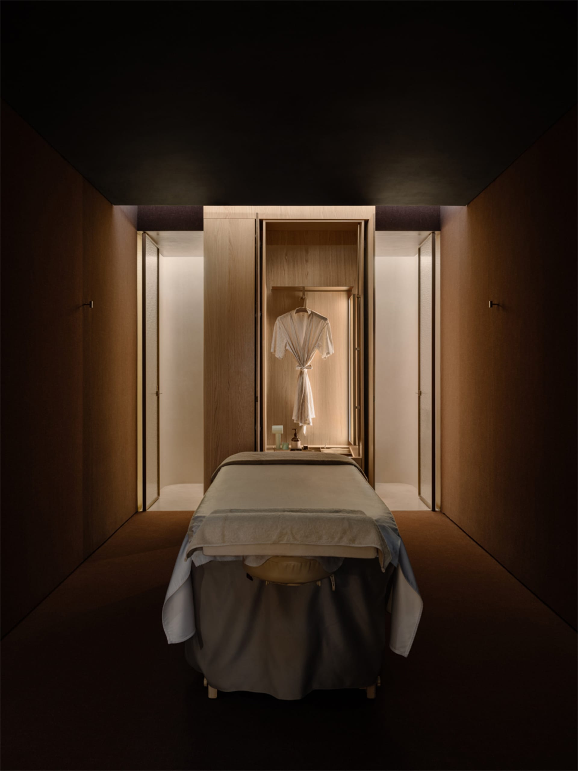 Cozy bedroom with a bed, chair, and closet, featuring a wooden floor and inviting atmosphere