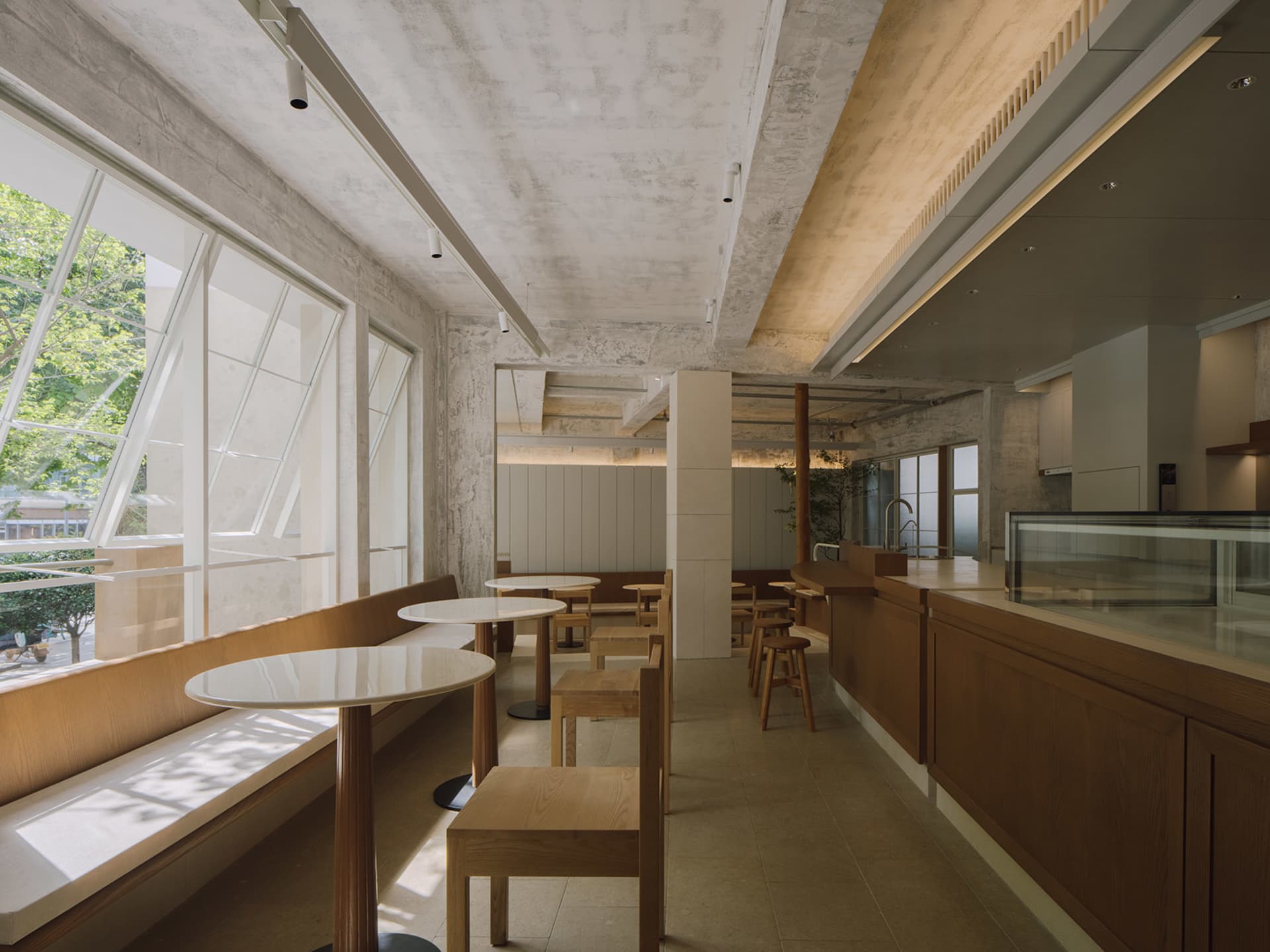 Bright and inviting restaurant interior with wooden furniture, white walls, and natural lighting