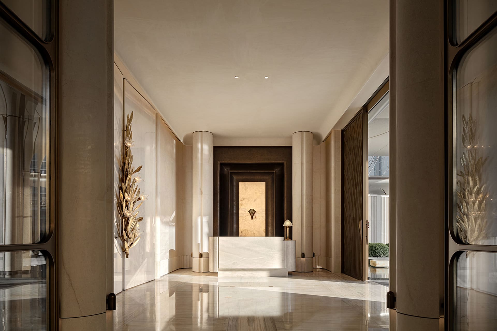 Well-lit lobby with a marble floor, a white desk, and a chair, creating an elegant and inviting atmosphere