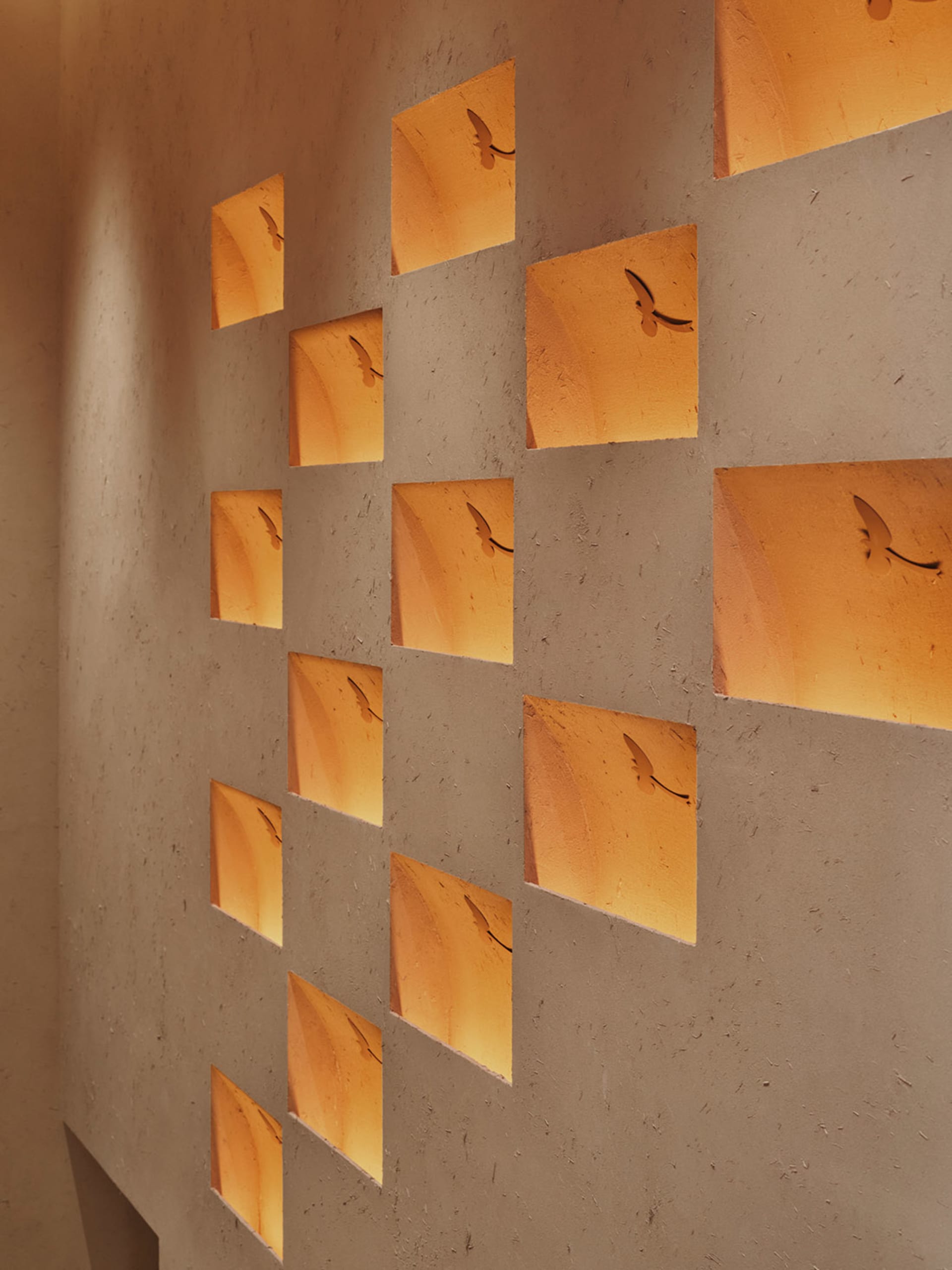 A cozy living space with a unique bird cutout wall design, soft lighting, and light-colored walls
