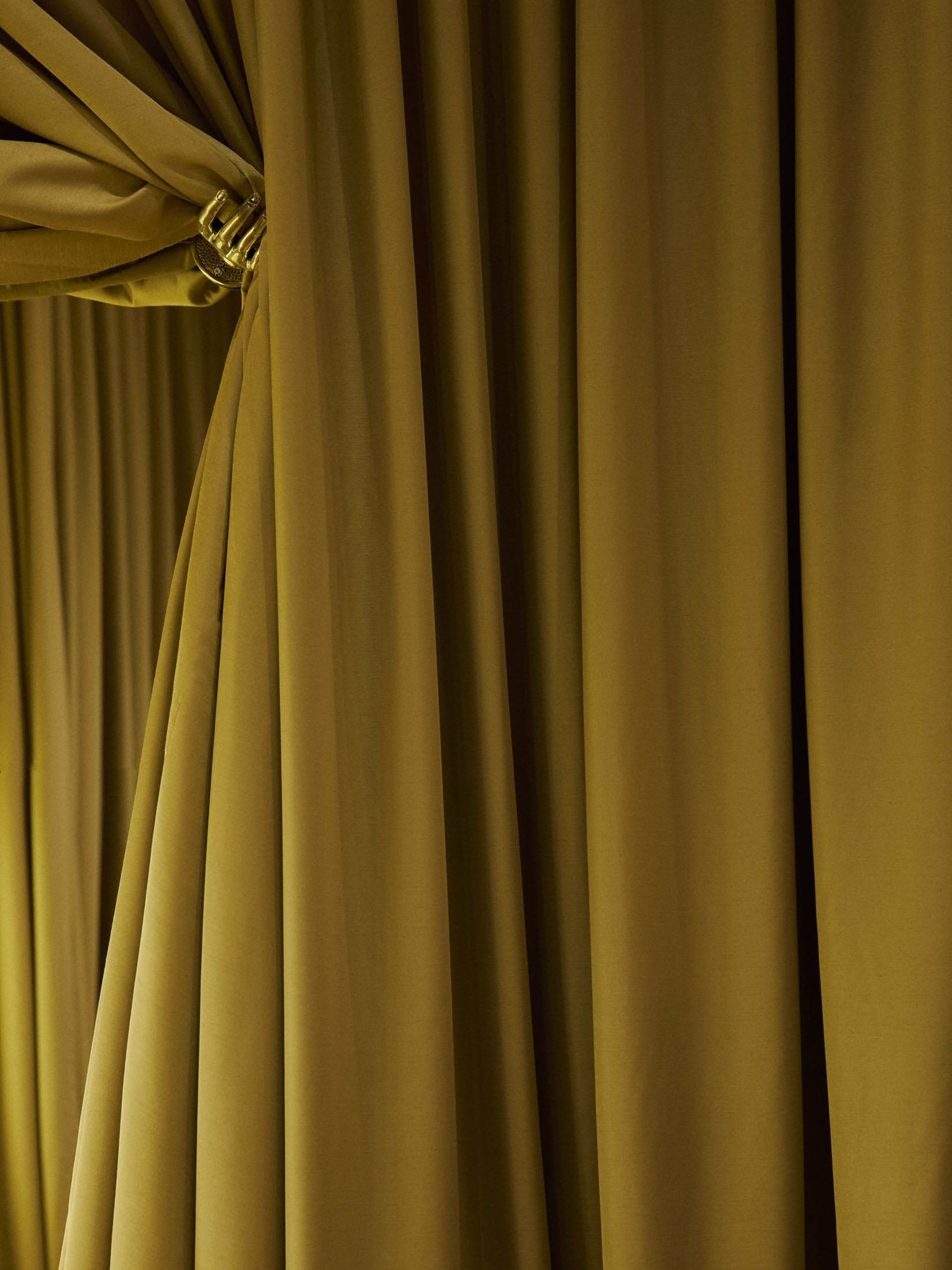 Dimly lit room with yellow curtains, a traditional interior with classic elements
