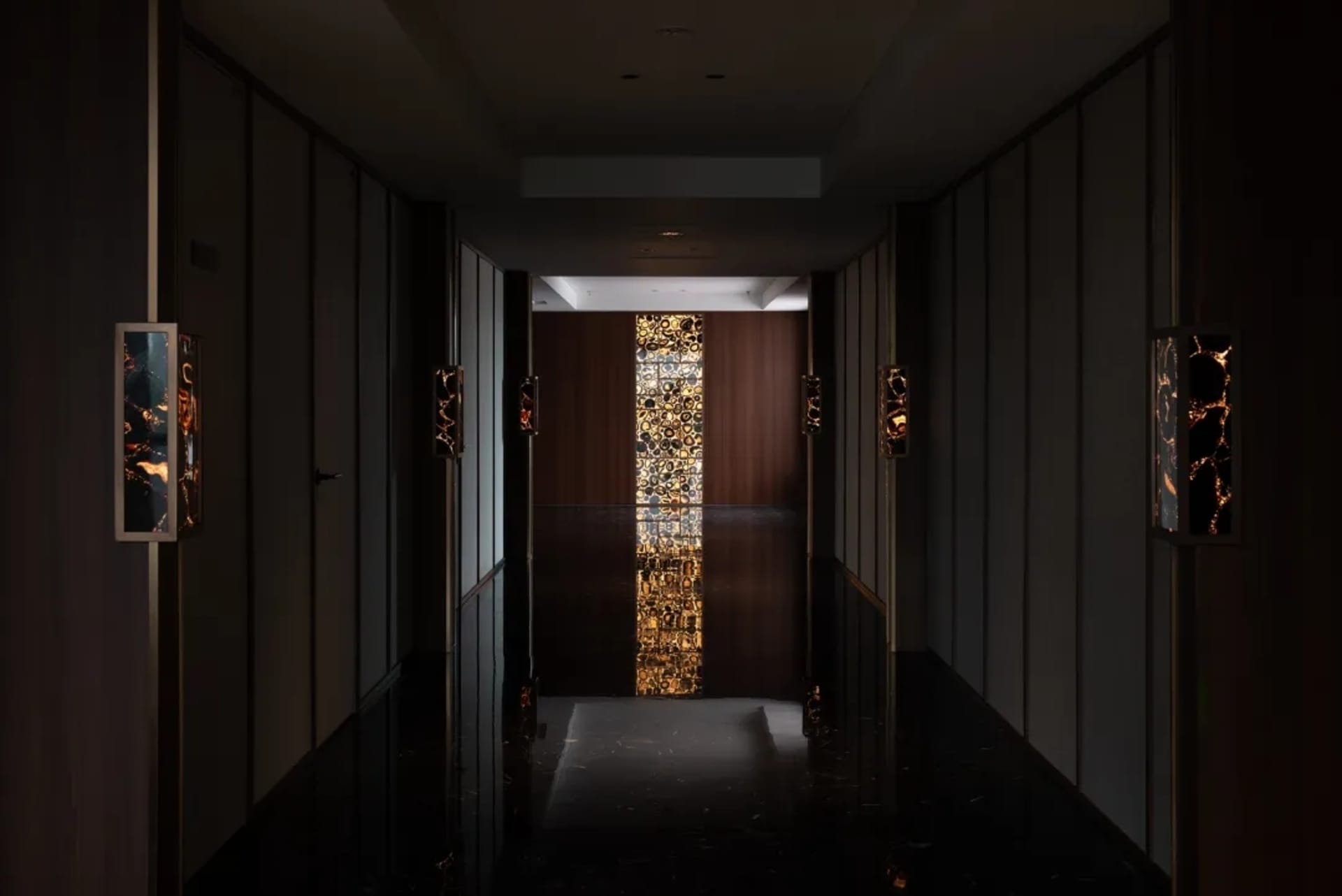 一間傳統走廊，木質牆壁和地毯地板，掛著門