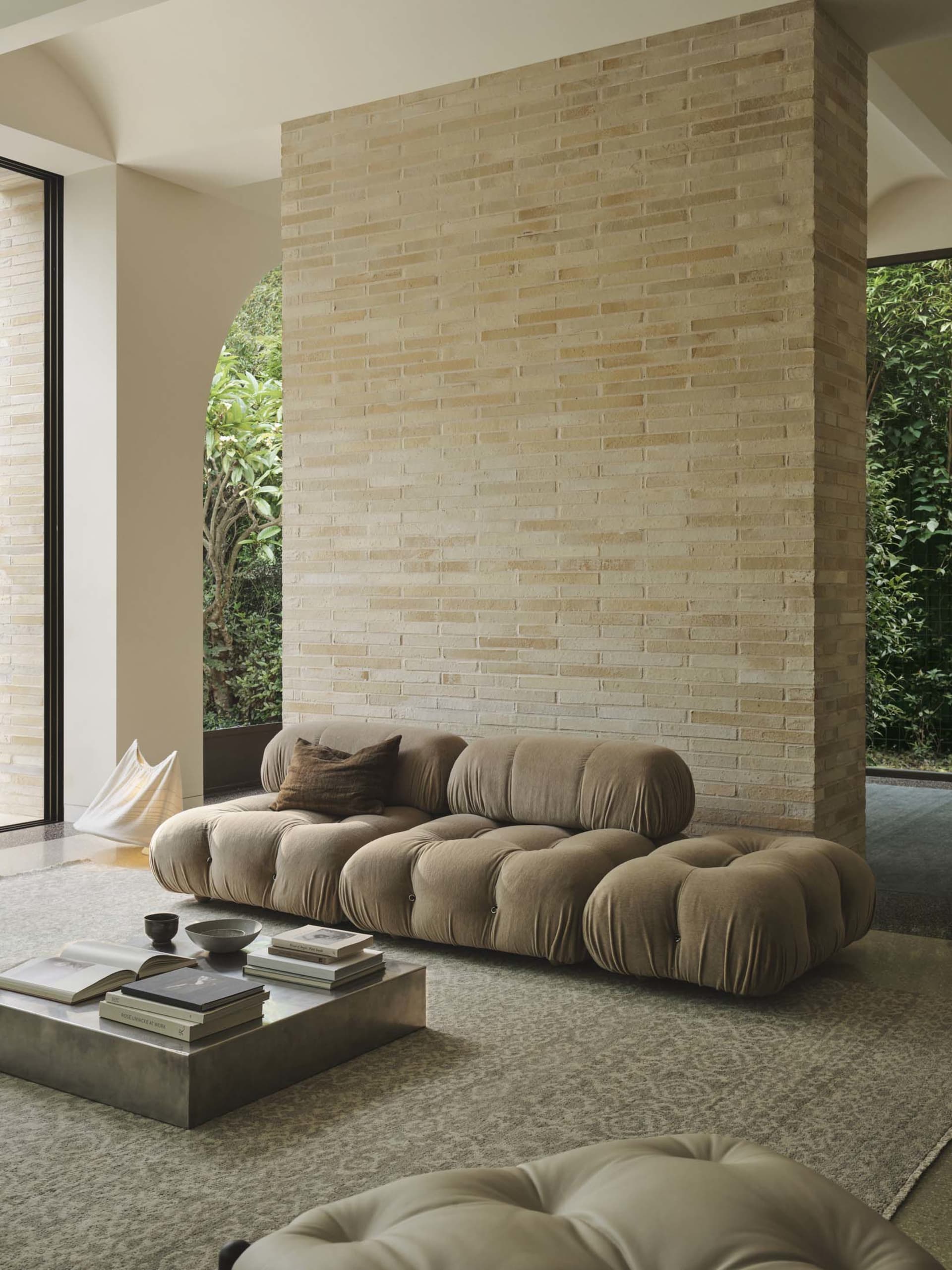Comfortable modern living space with a leather sofa, wooden coffee table, and warm lighting