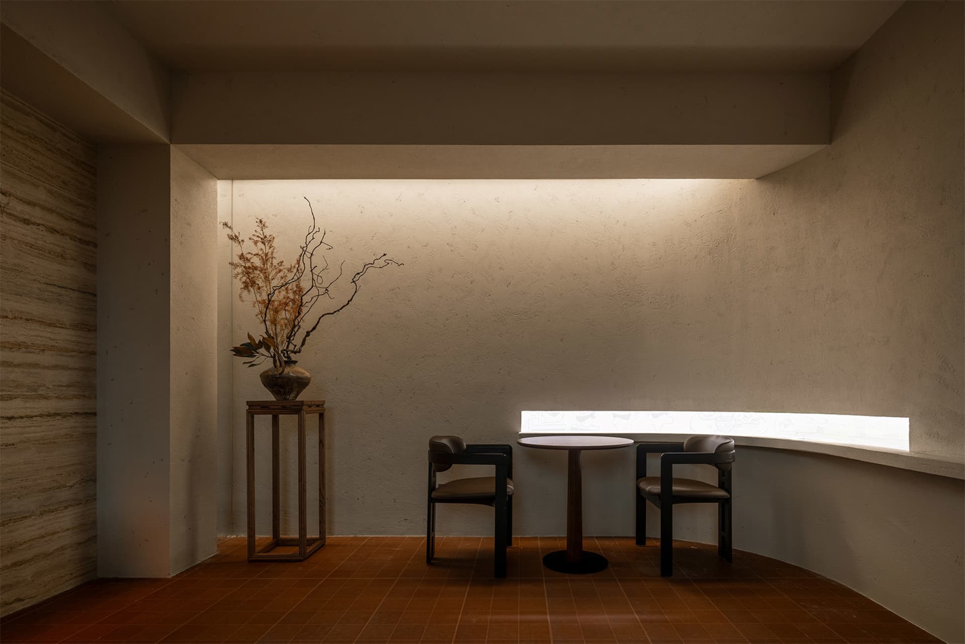A cozy dining area with a wooden table and four chairs, surrounded by a warm and inviting atmosphere