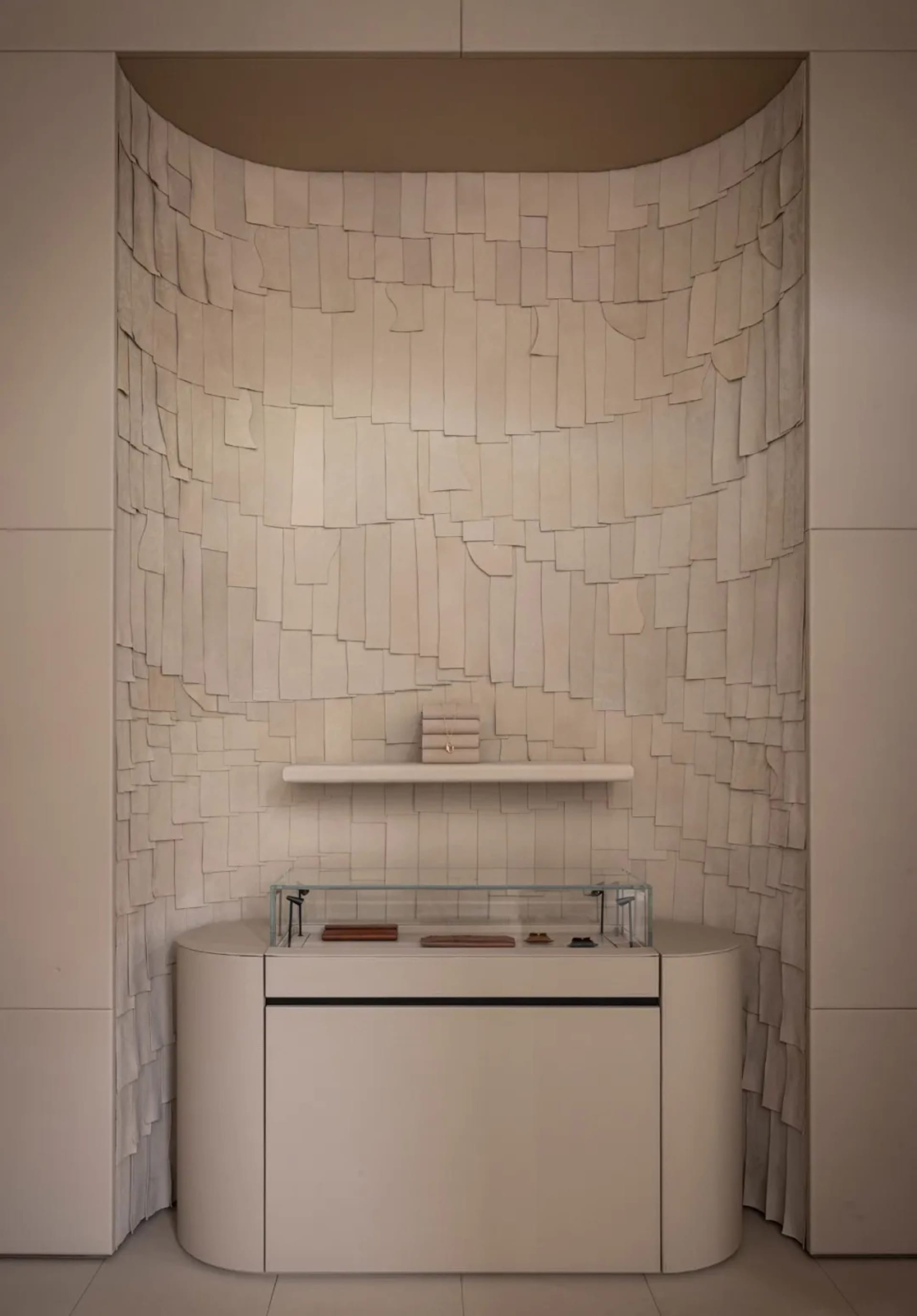 Bathroom with a white marble countertop, a wooden shelf, a sink, and a mirror, with dim lighting creating a cozy atmosphere