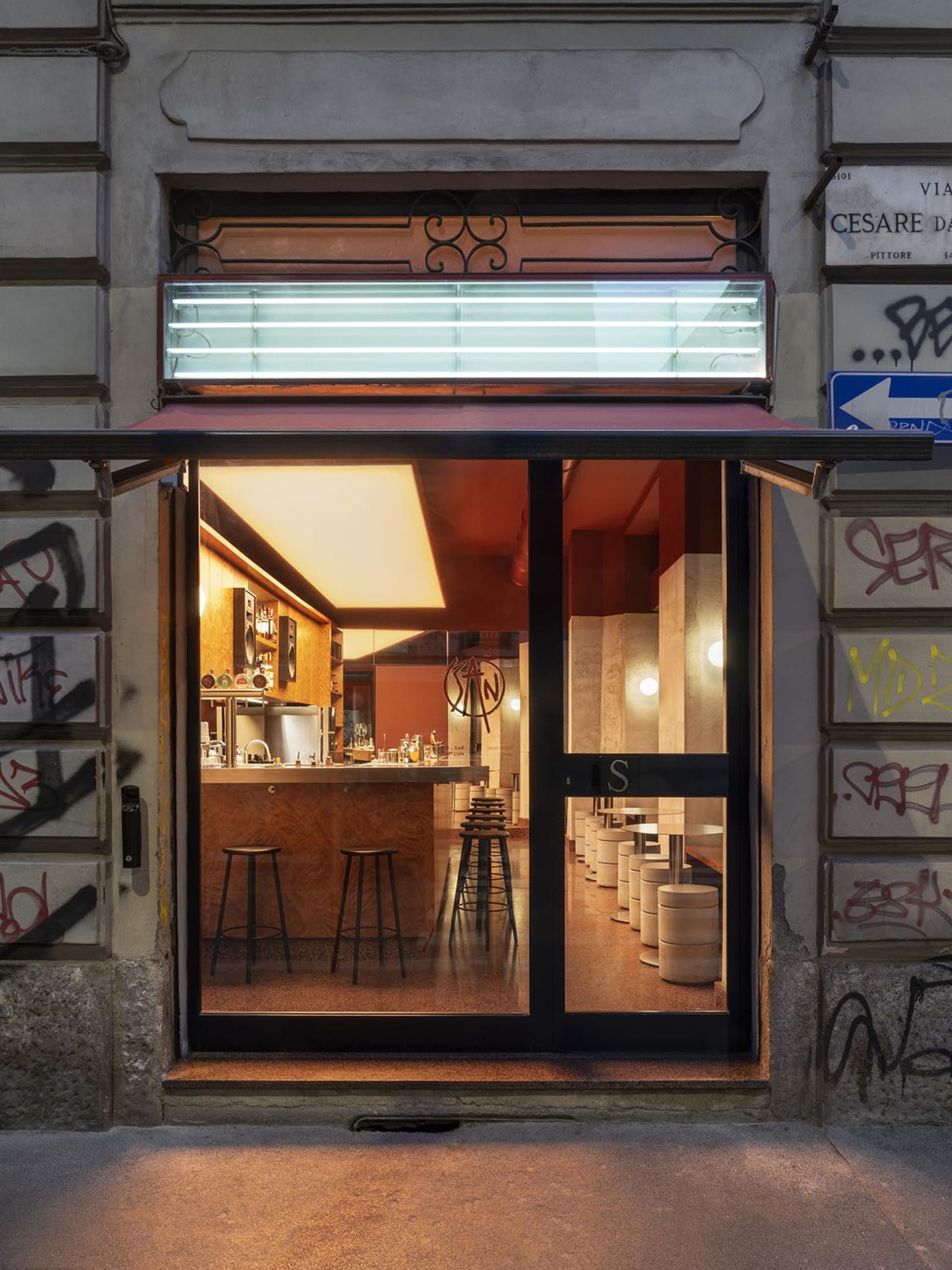 A well-lit restaurant interior with a modern bar, comfortable seating, and neutral colors