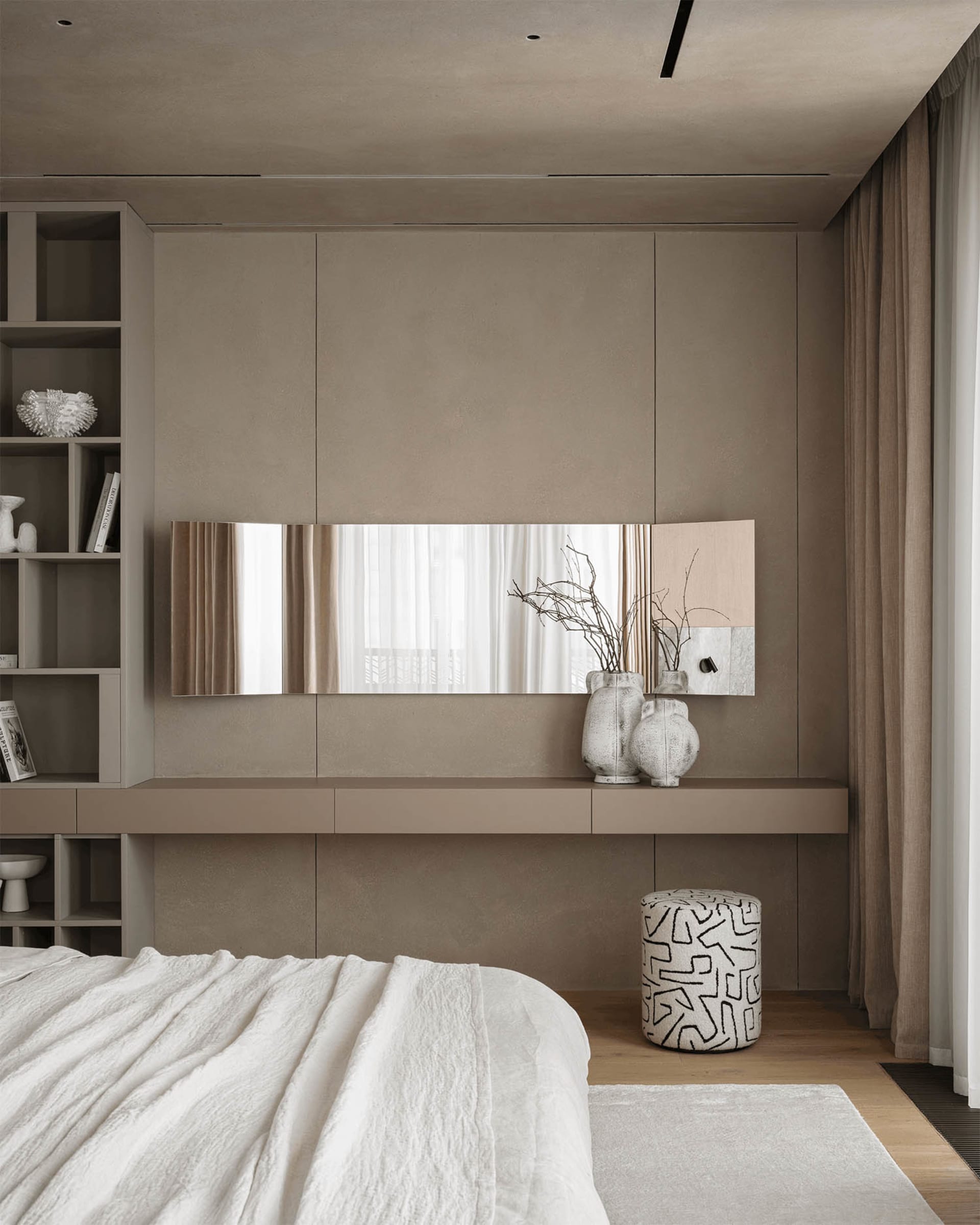 A calm and serene bedroom with a white bed and mirror, featuring a clean and minimalist design with a focus on functionality and simplicity