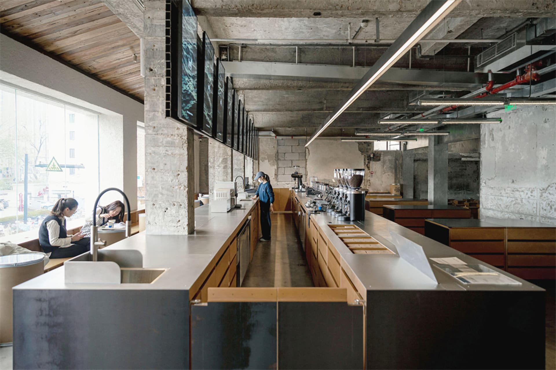 A bustling restaurant with a stainless steel counter, modern industrial design, and a lively atmosphere