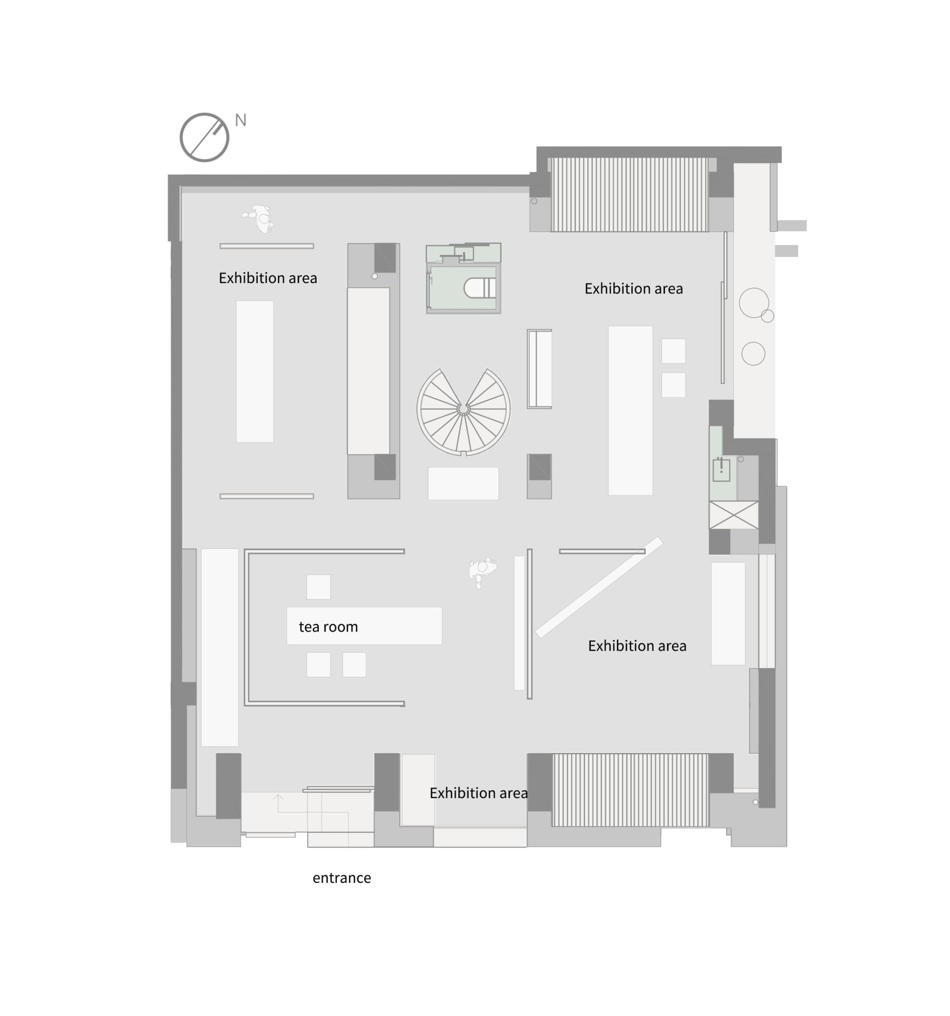 White and black floor plan of a modern building with multiple rooms and a central lobby or exhibition space, featuring clean lines and a focus on functionality
