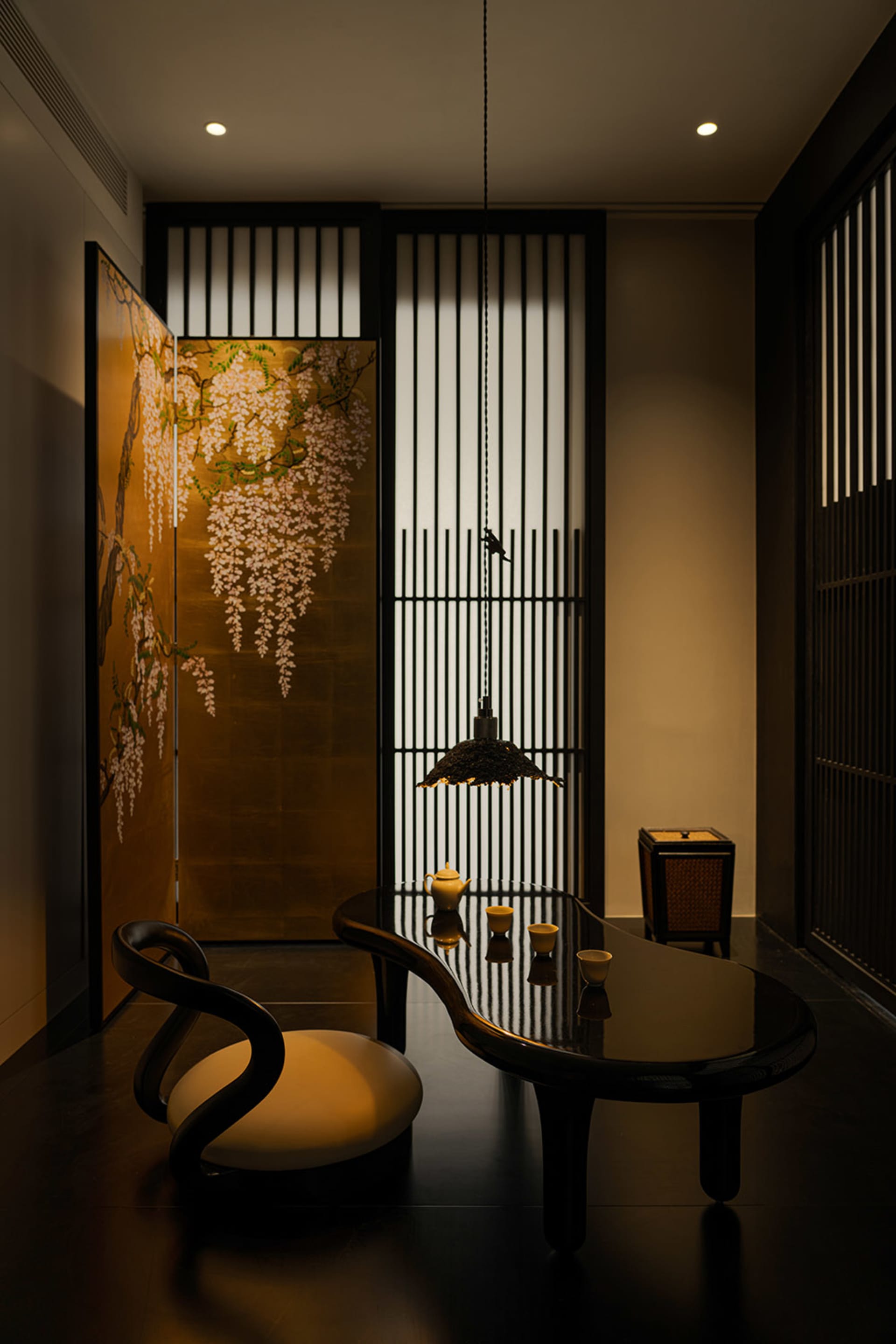 Cozy dining space with a wooden table and chairs, dimly lit with a doorway in the background