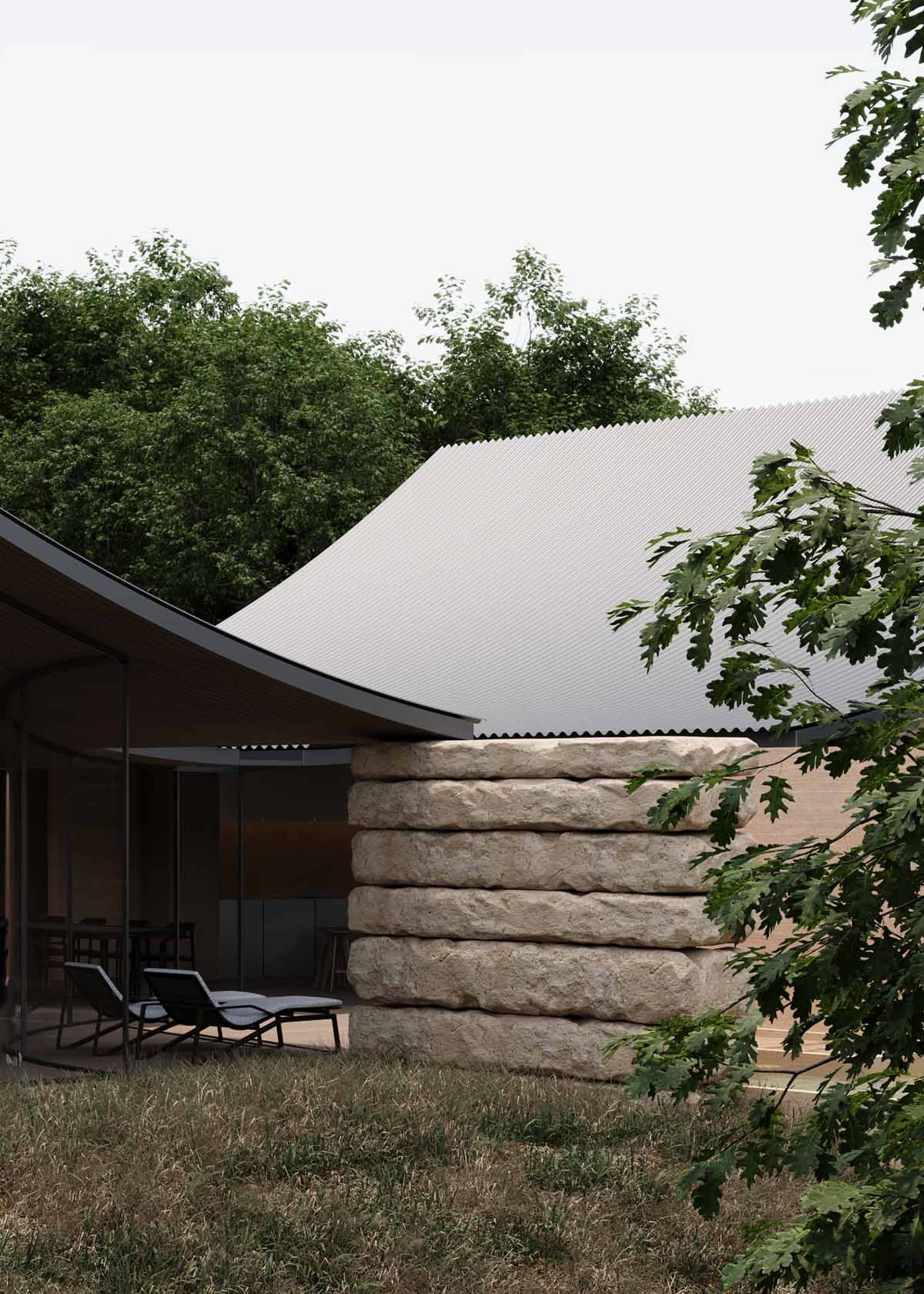 A modern house with a stone facade and a patio area featuring a dining table and chairs, set in a relaxed and inviting outdoor space