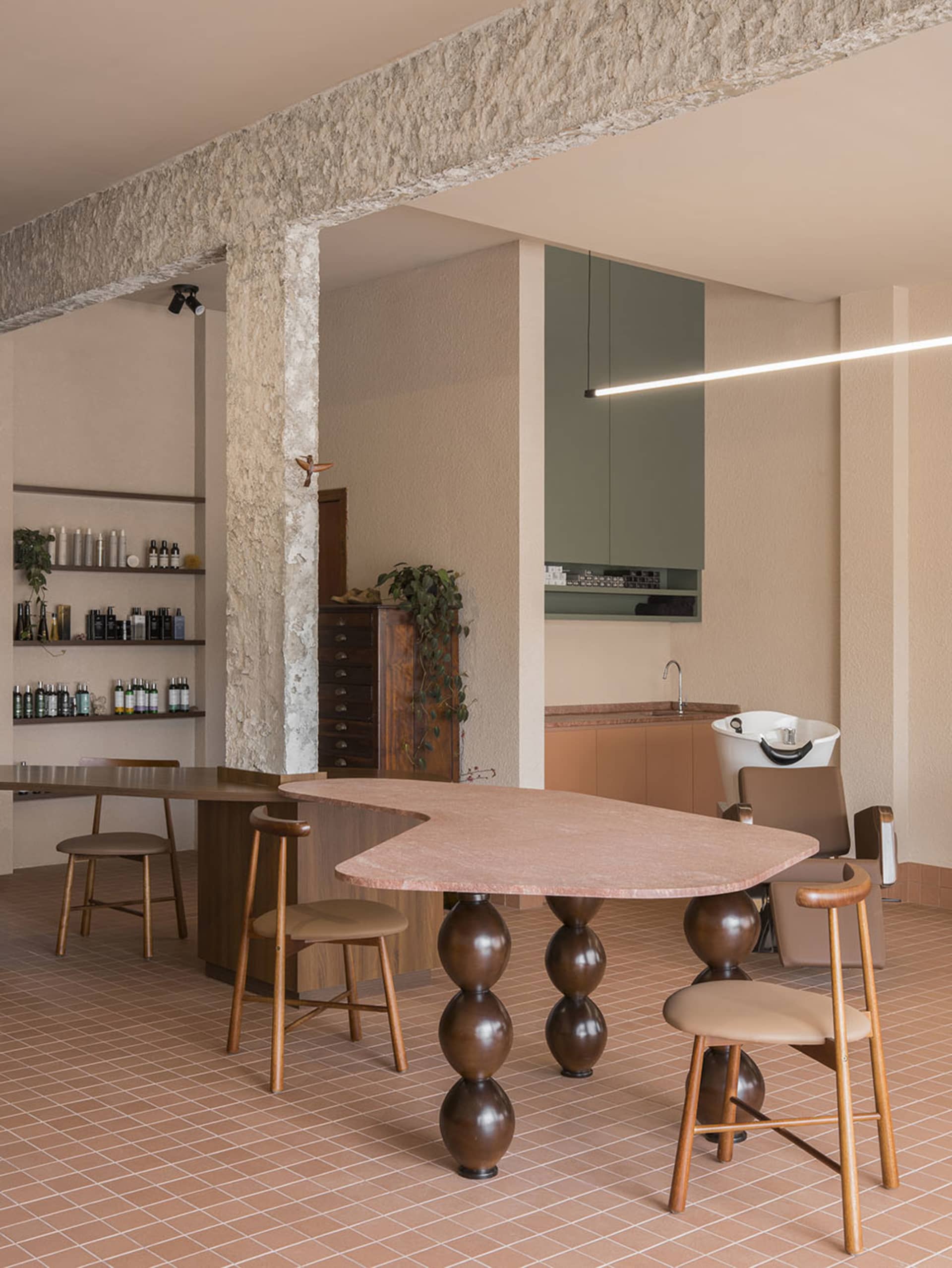 Spacious modern dining room with a large dining table, wood and stone materials, and a well-lit atmosphere