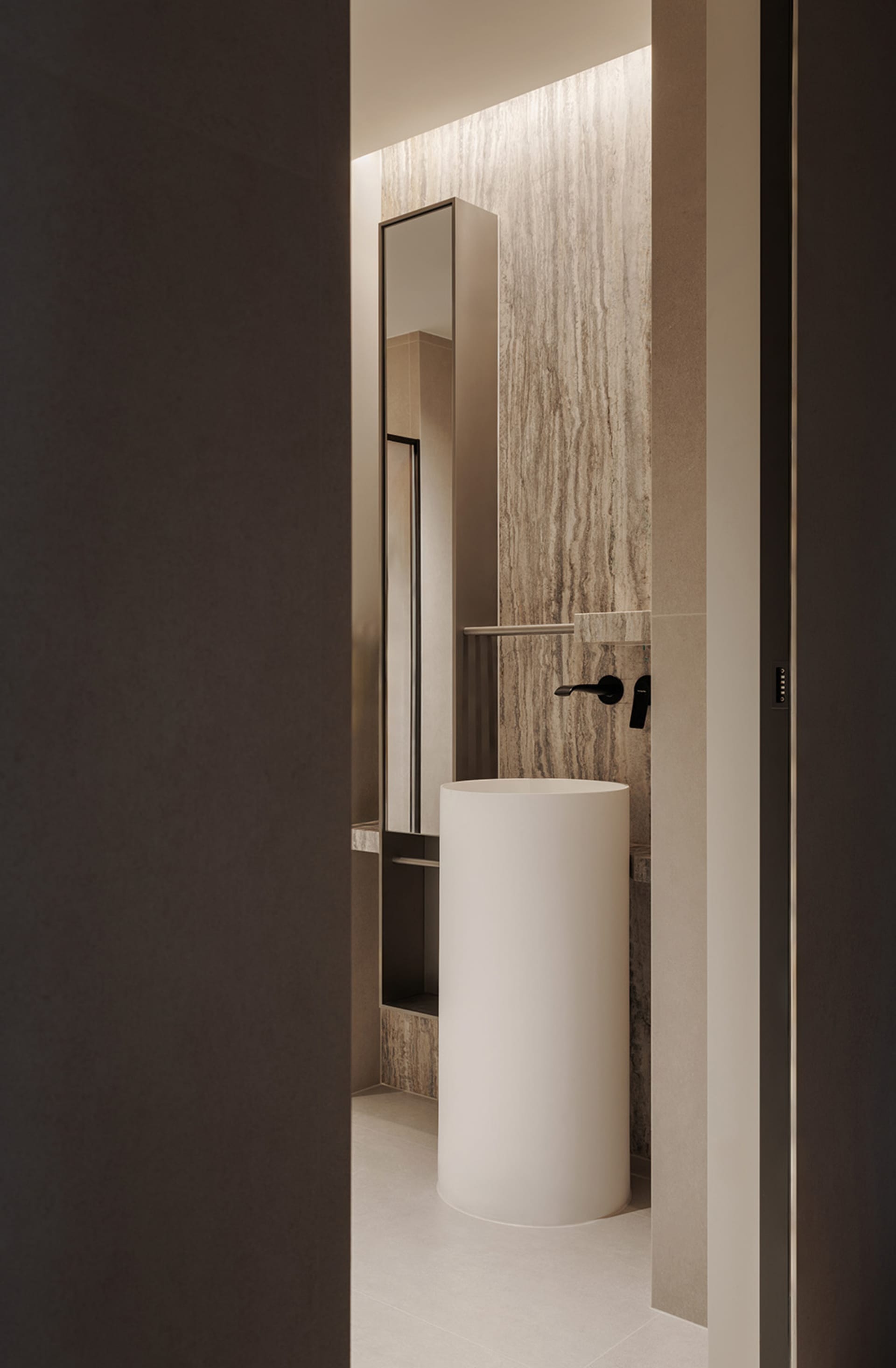 A well-lit bathroom with a white toilet, sink, and mirror, creating a clean and modern atmosphere