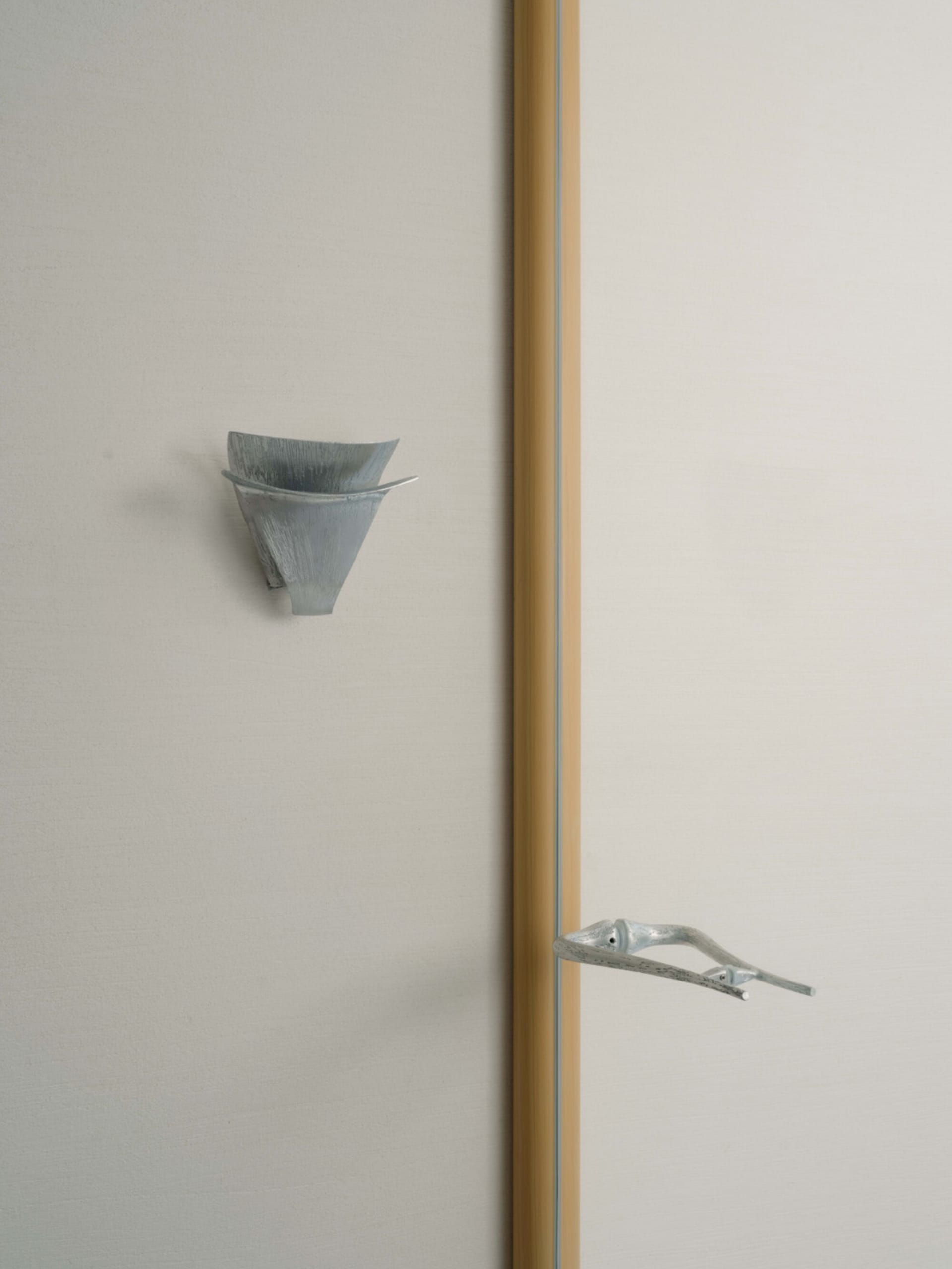 Bathroom with a wooden wall, metal towel rack, sink, and toilet, featuring a blend of traditional and contemporary elements