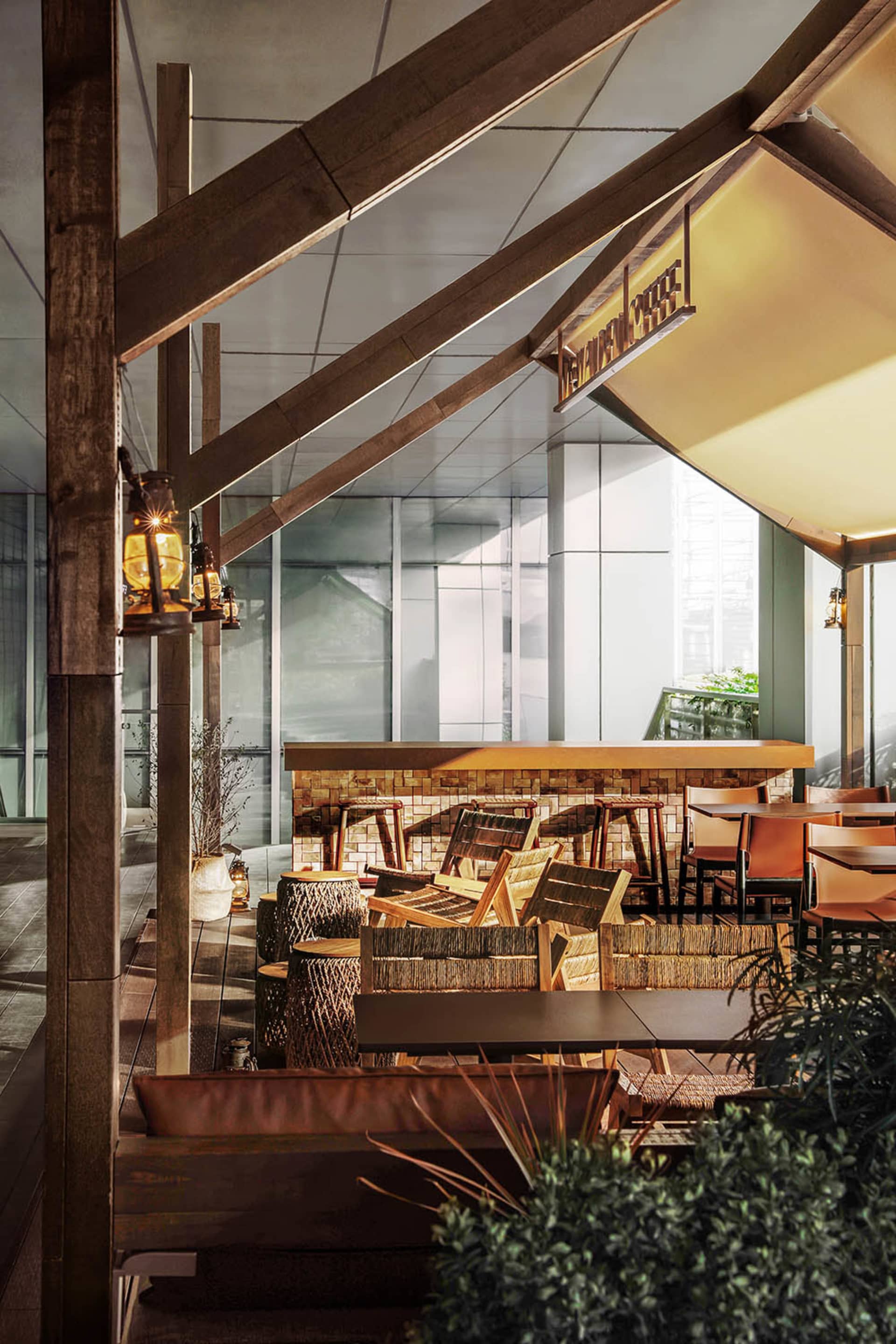 A modern outdoor restaurant with a patio area filled with tables and chairs, featuring wood and metal materials and natural sunlight