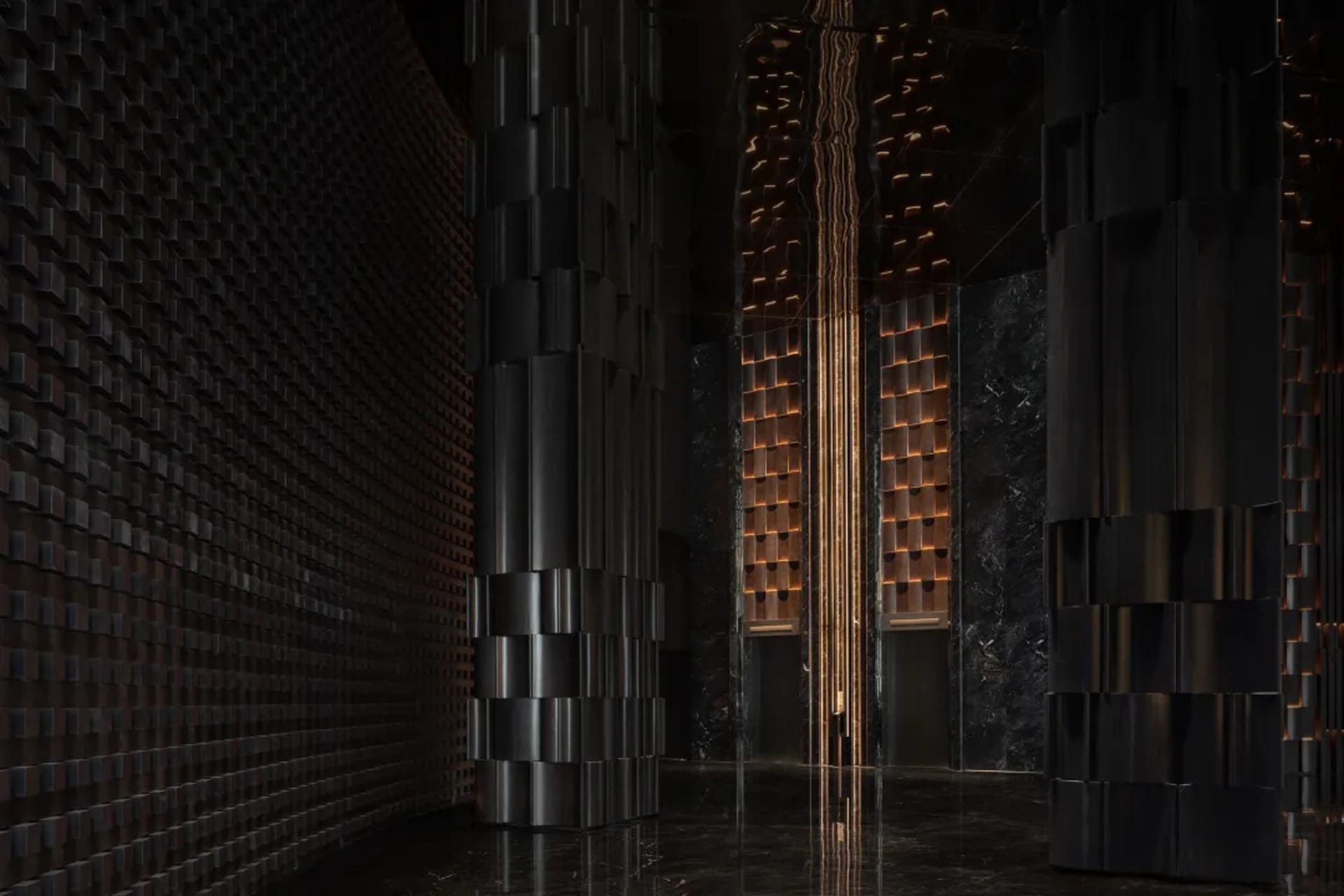 A dimly lit hallway with modern stone-like columns and a minimalist aesthetic