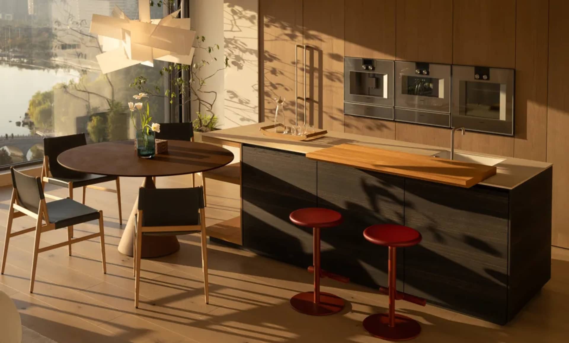 Kitchen with wooden cabinets and island, dining table, and natural light from windows