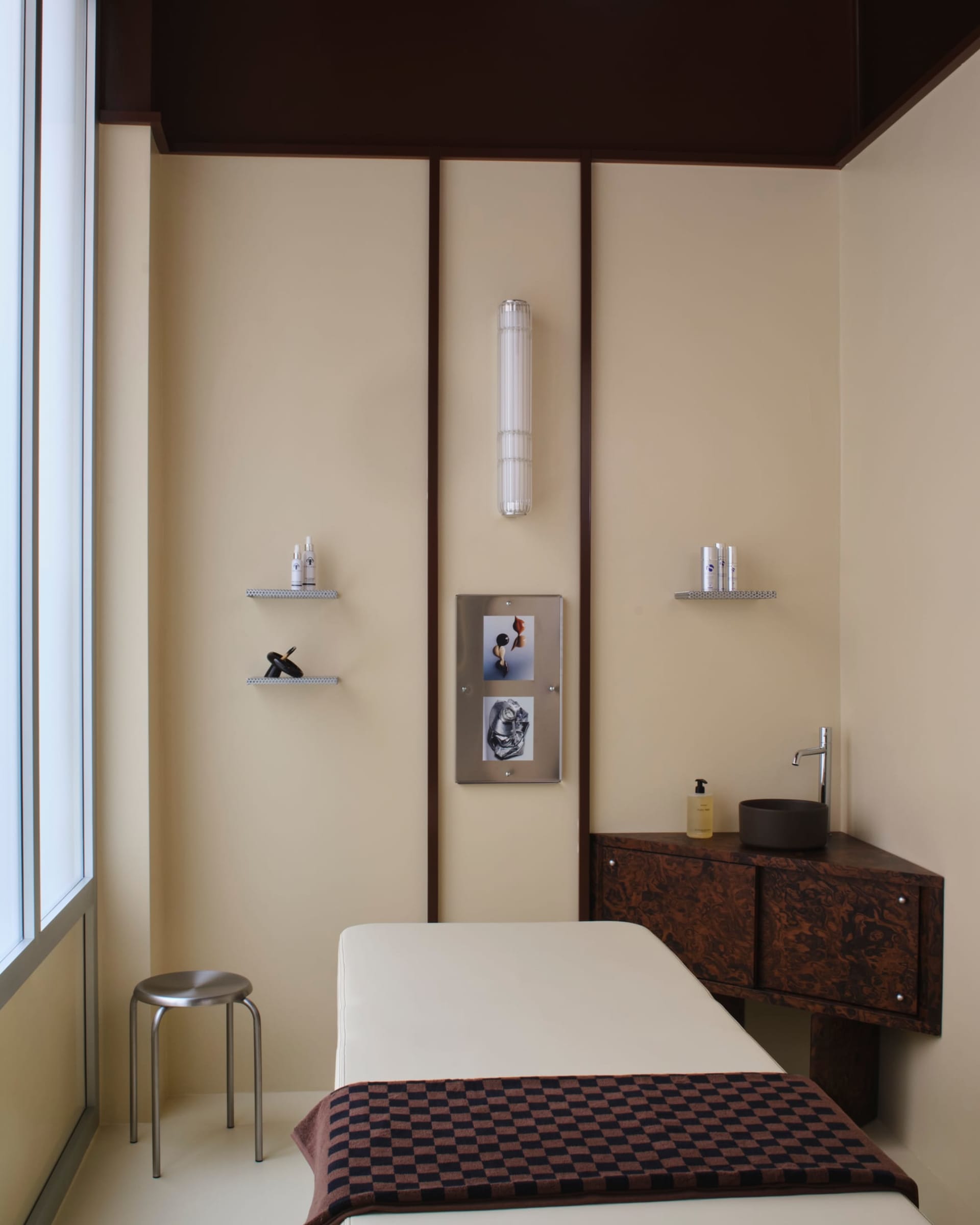 Cozy bedroom with a brown wooden bed, table, and chair, creating a warm and inviting atmosphere