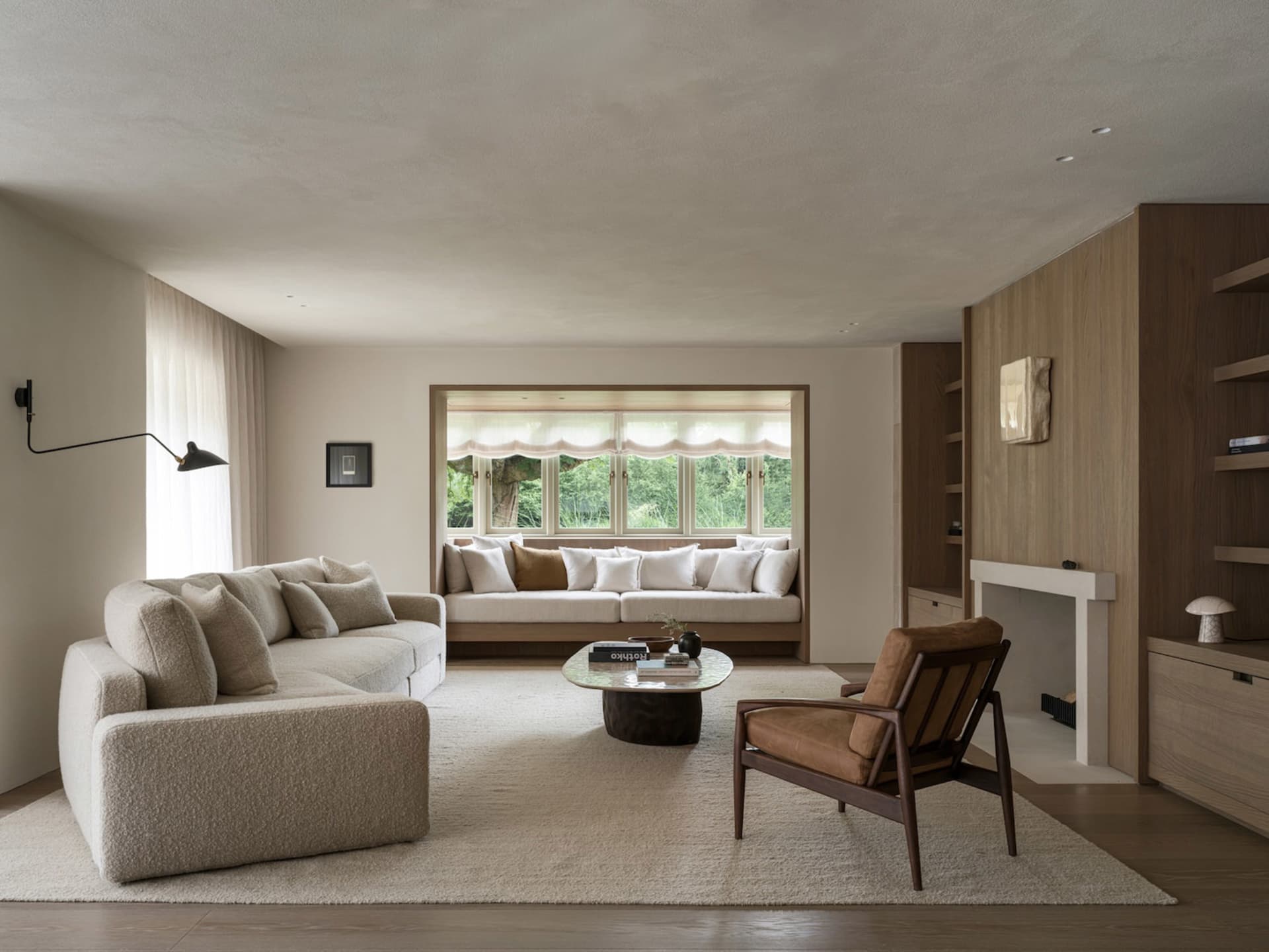 Cozy living room with a brown couch, a chair, a coffee table, and a fireplace, creating a warm and inviting atmosphere