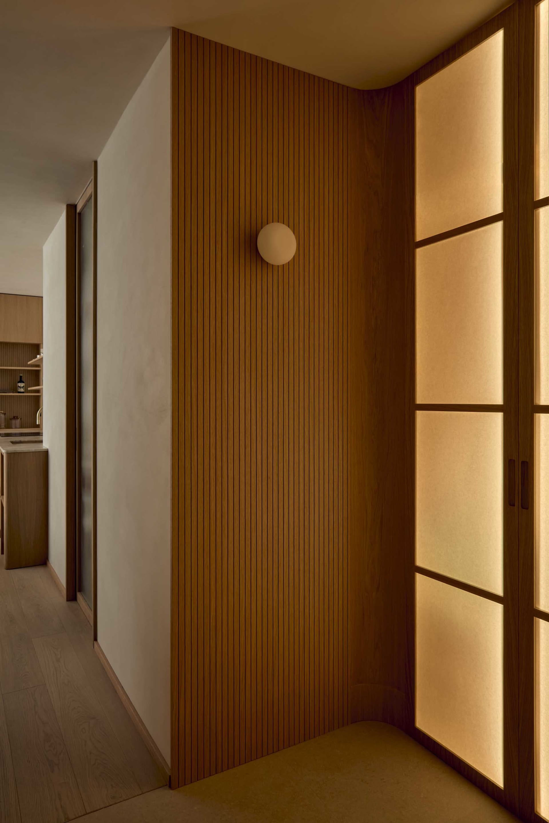 Cozy kitchen with wooden walls, a wooden door, and dim lighting