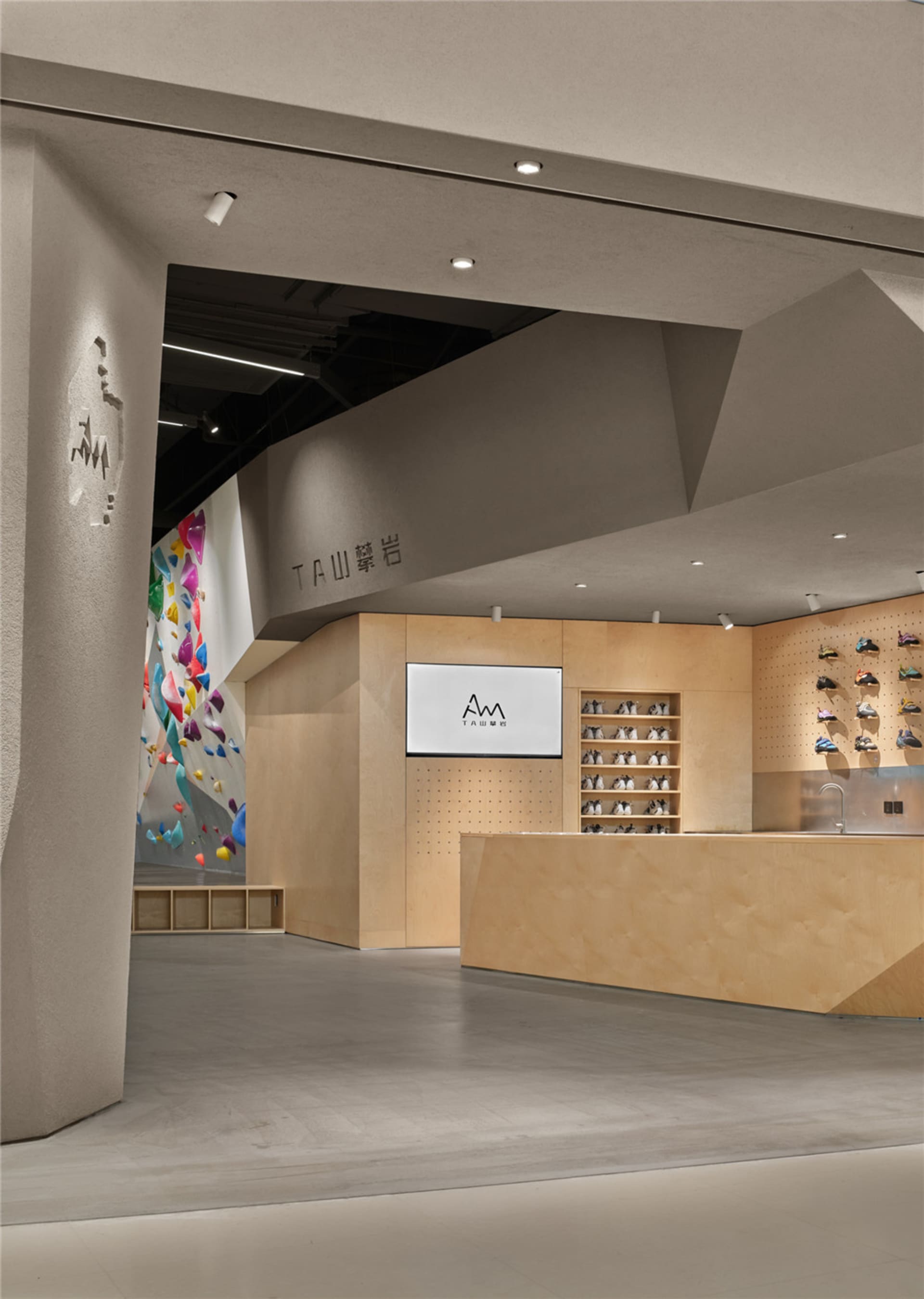 一間木櫃櫃台的鞋店，背景照明 dimly lit，牆上有電視，周圍有展示的鞋子
