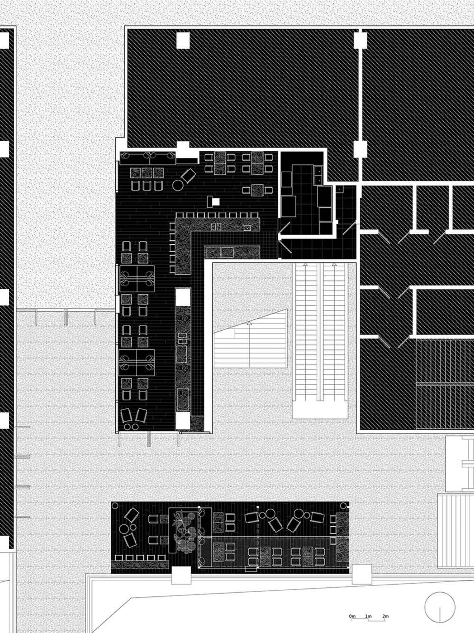 Black and white floor plan of a commercial building with room outlines, labels, measurements, and symbols, featuring a minimalist layout and natural lighting