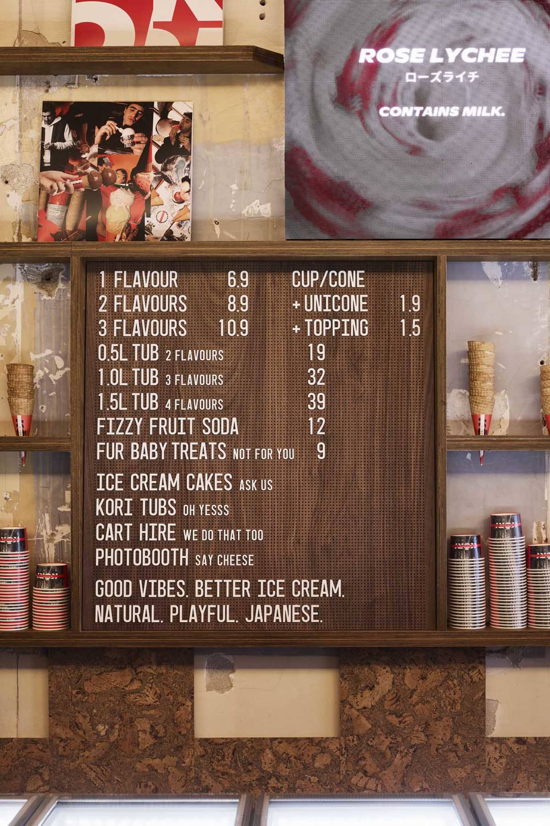 A wooden menu board with a brown color, featuring a variety of food items and drinks in English and Japanese, creating an inviting atmosphere
