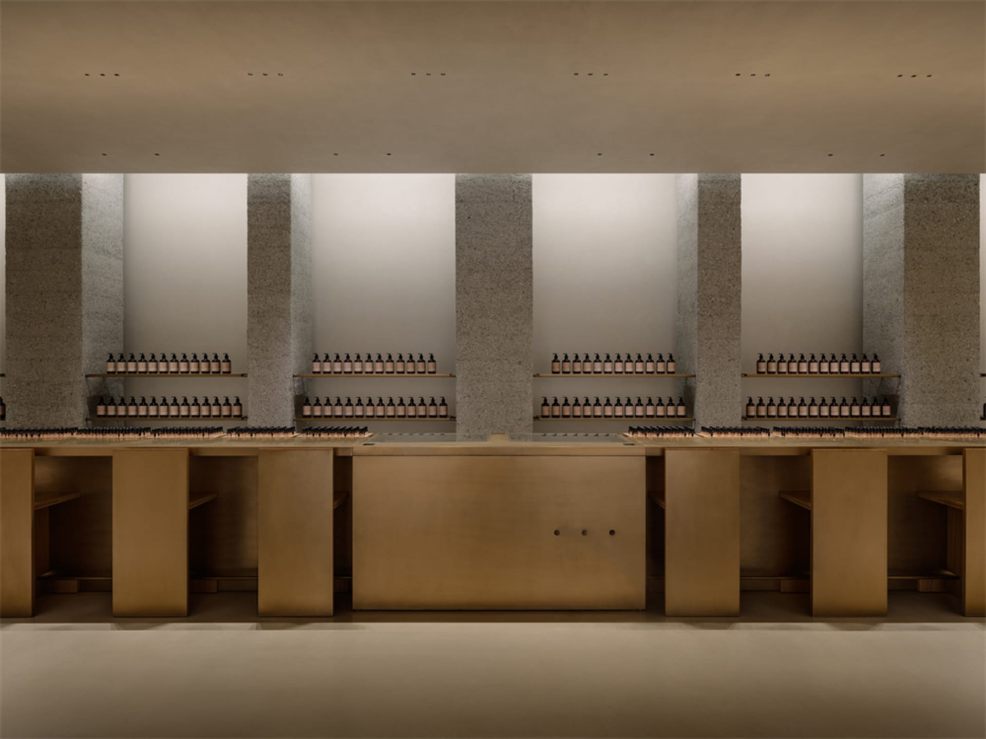 A bright and organized store with rows of bottles on shelves and a counter, creating a welcoming atmosphere for shoppers