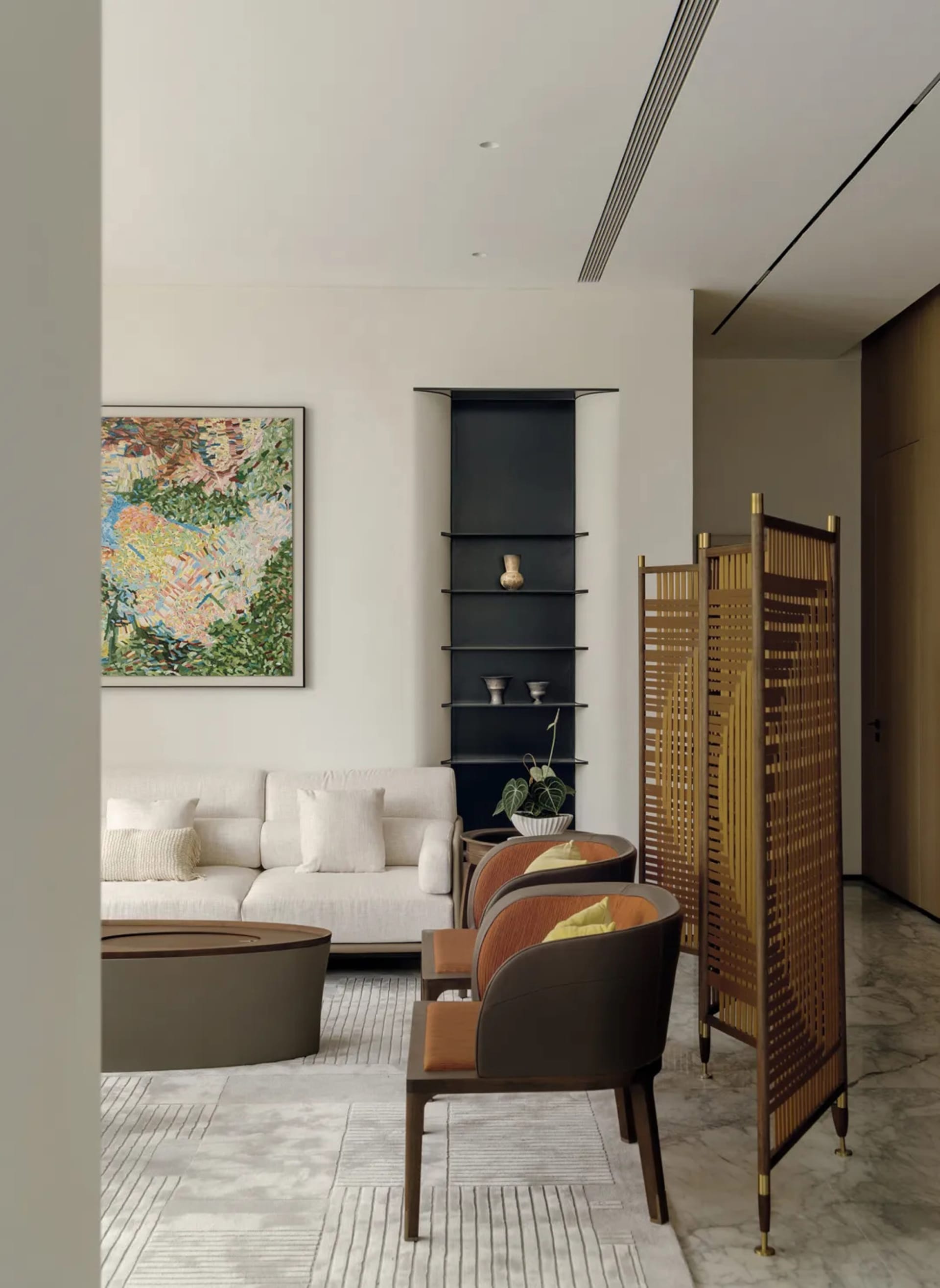 A well-lit living room with a couch, chair, and bench made of wood, decorated with a painting and natural light from windows