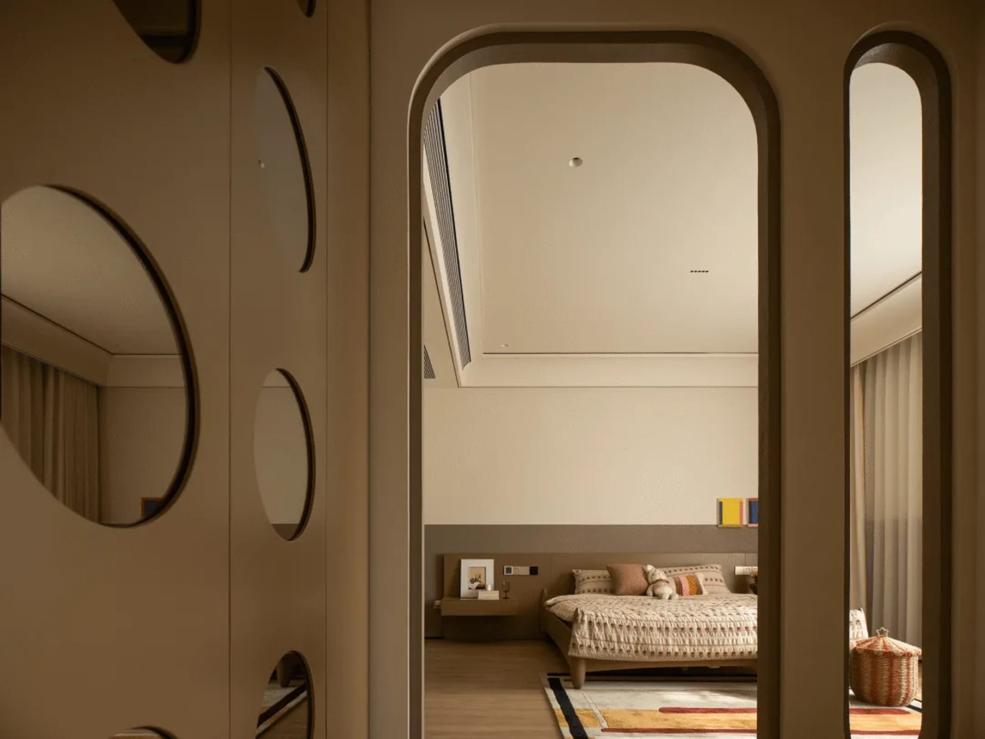 Cozy modern bedroom with a wooden floor, a bed, a couch, and a chair, decorated with a soft and warm atmosphere