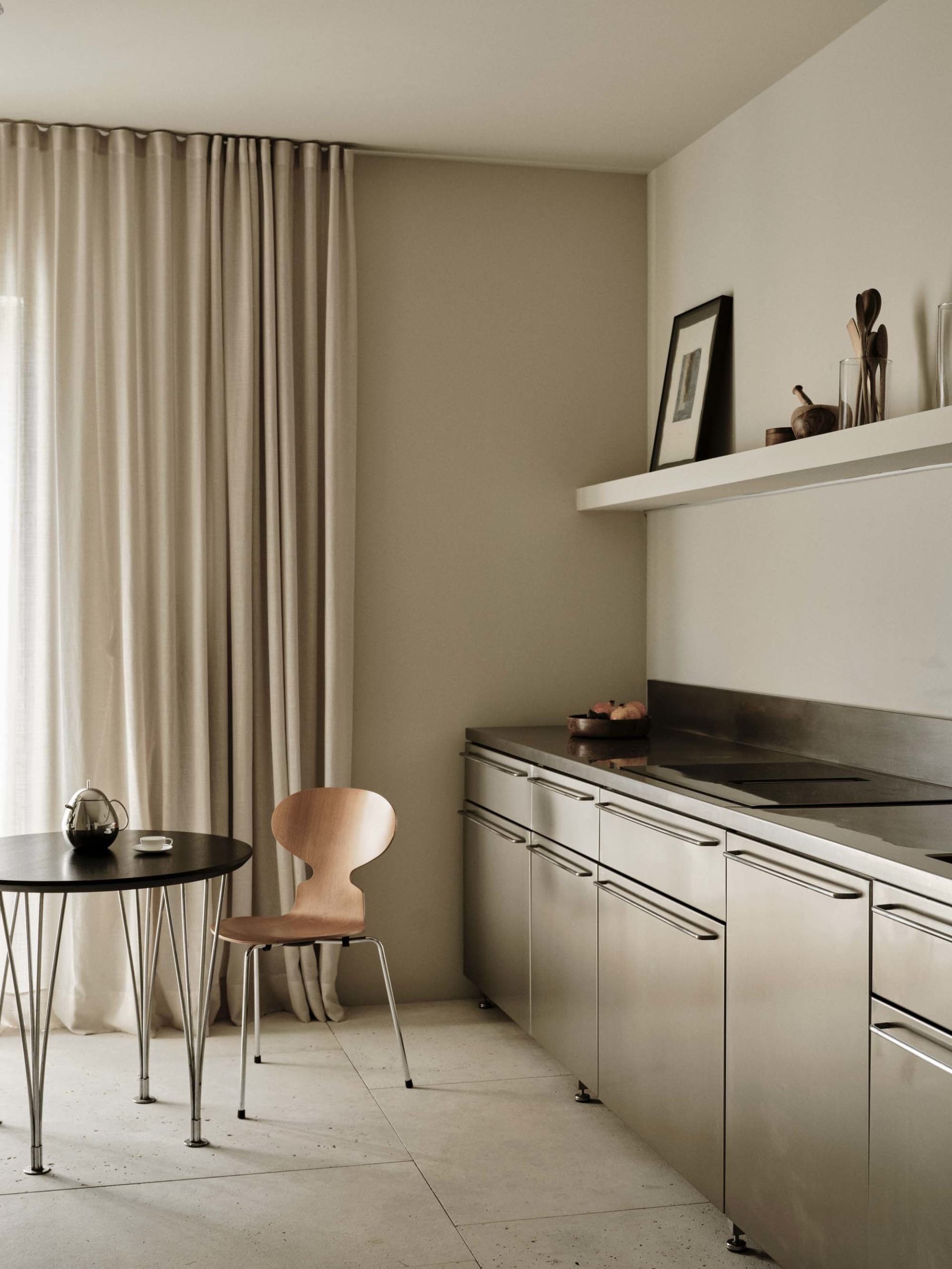 Modern kitchen with stainless steel appliances, marble countertops, and a well-lit space