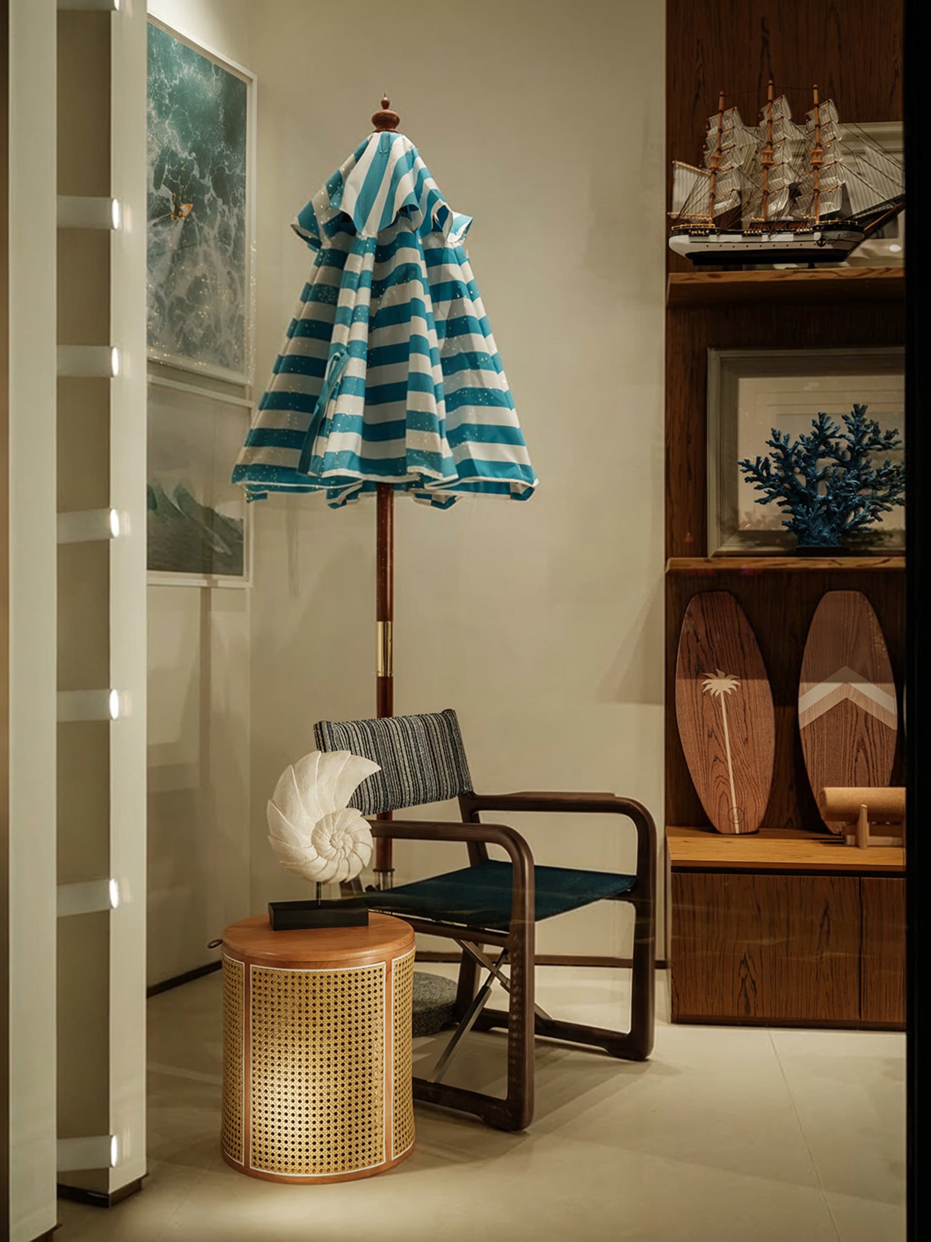 A modern living room with a blue and white striped umbrella hanging from the ceiling, a chair, table, and surfboard, with a warm and natural feel from the wood materials and well-lit atmosphere