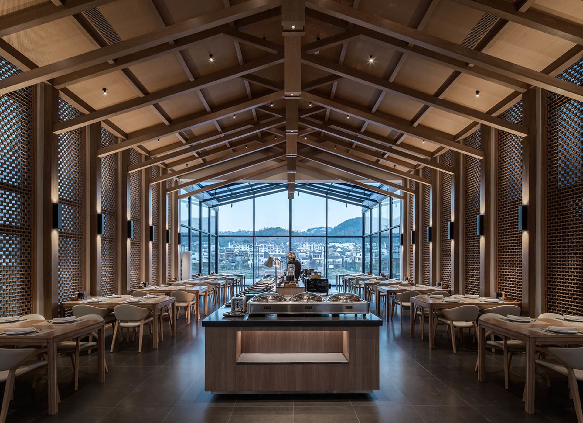 A modern restaurant with wooden elements, natural light, and various dining tables and chairs, creating an inviting atmosphere