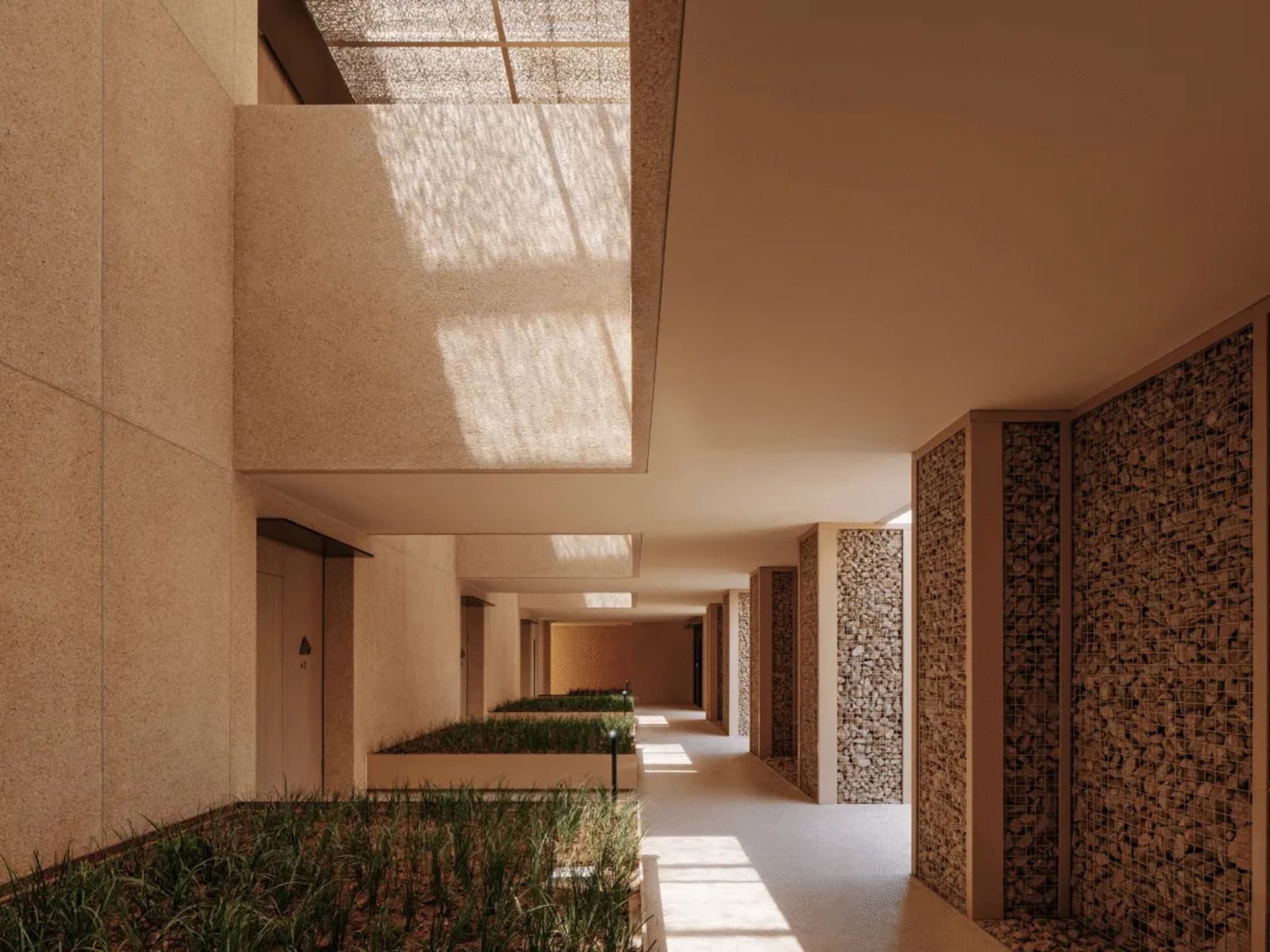 A well-maintained indoor hallway with a row of windows, lined with potted green plants, creating a pleasant atmosphere