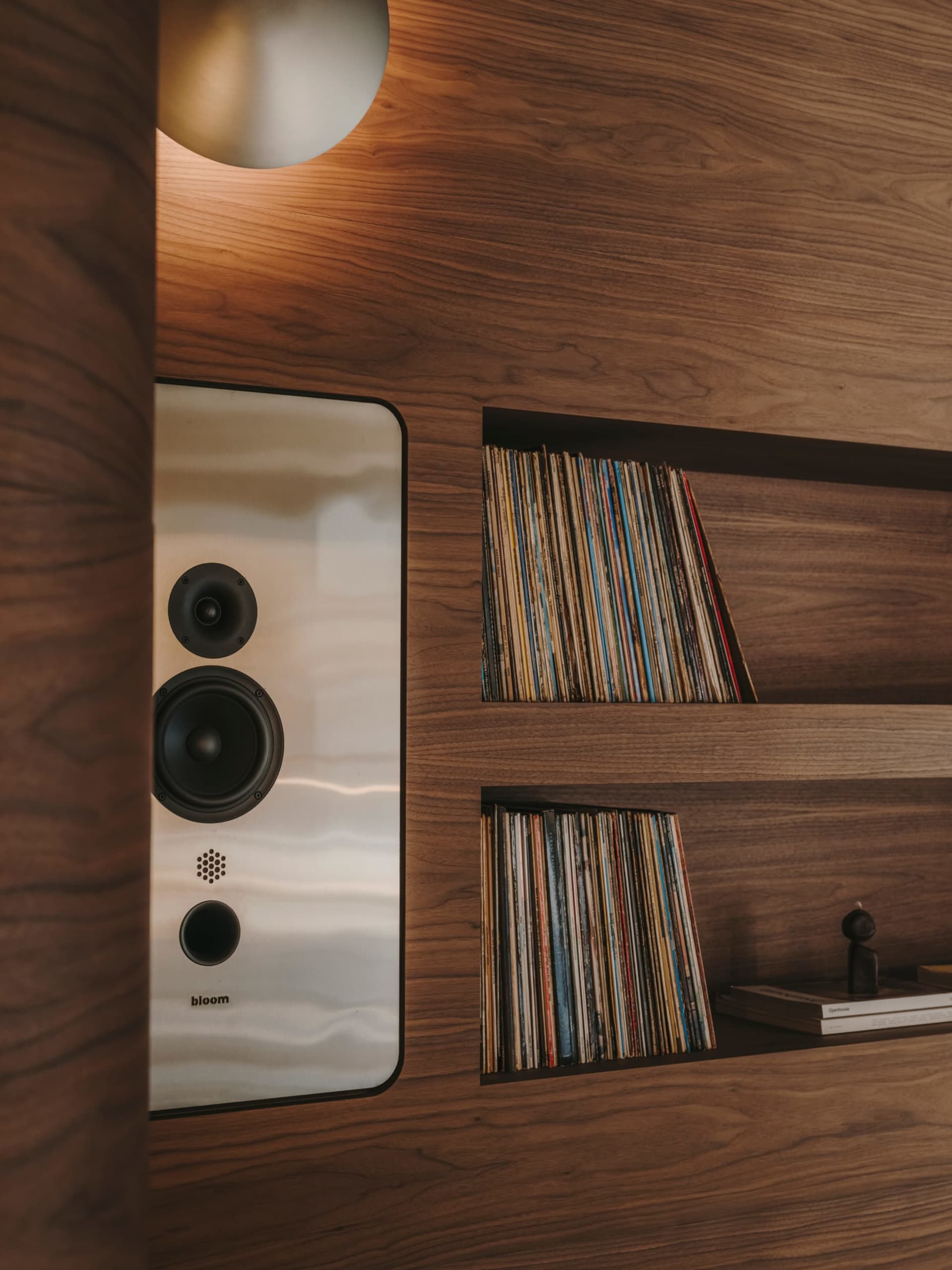 A cozy book-filled space with a wooden bookshelf and a variety of books arranged in a visually interesting display