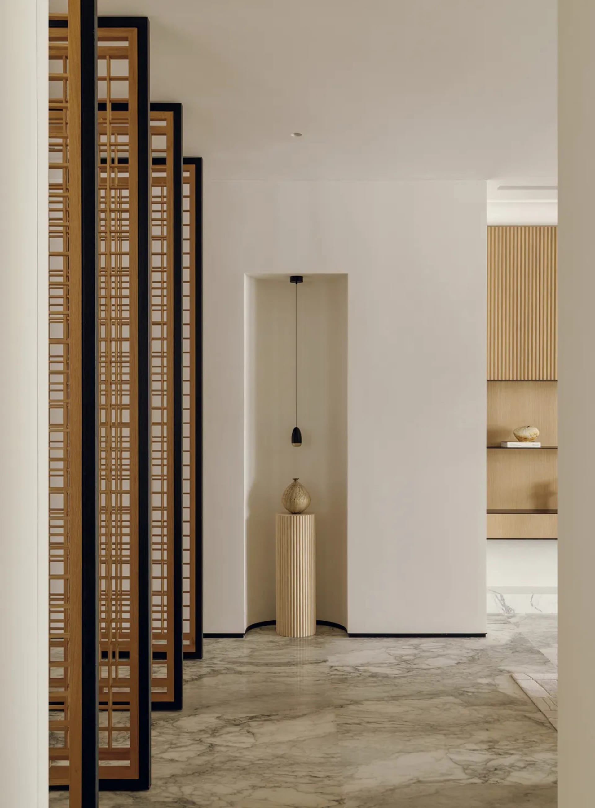 Dimly lit hallway with wooden floor, white wall, and wooden paneling, creating a cozy and intimate atmosphere