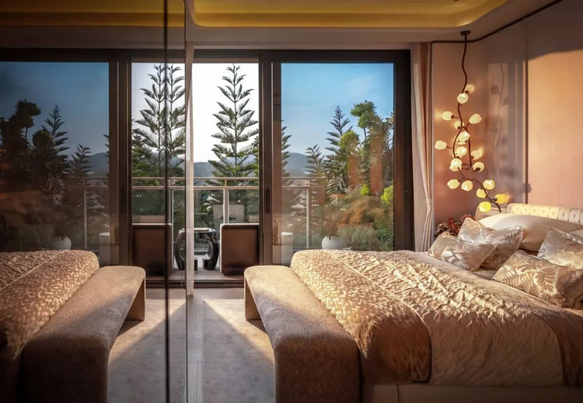 Comfortable living space with two couches and a chair facing a large window, a dining table in the background, and a potted plant near the window