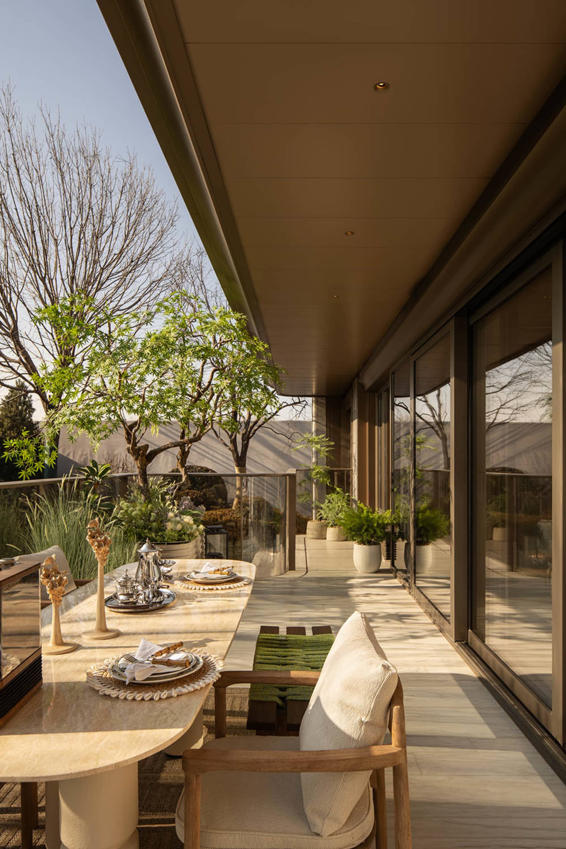 Cozy modern dining space with a set table, natural light, and a potted plant