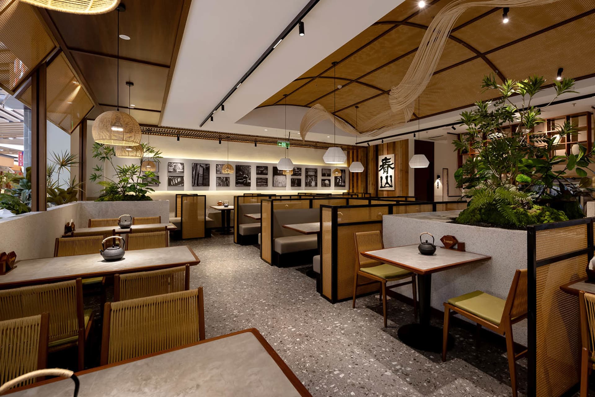 A modern restaurant with a large dining area featuring wood and metal elements, soft lighting, and a warm atmosphere
