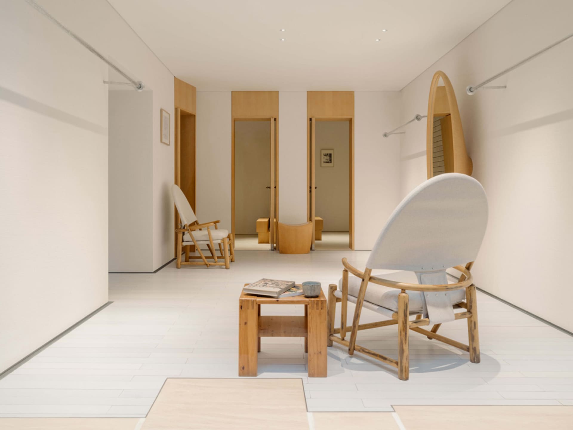 Comfortable living space with a wooden floor, a chair, a couch, and a bench, creating a warm and inviting atmosphere