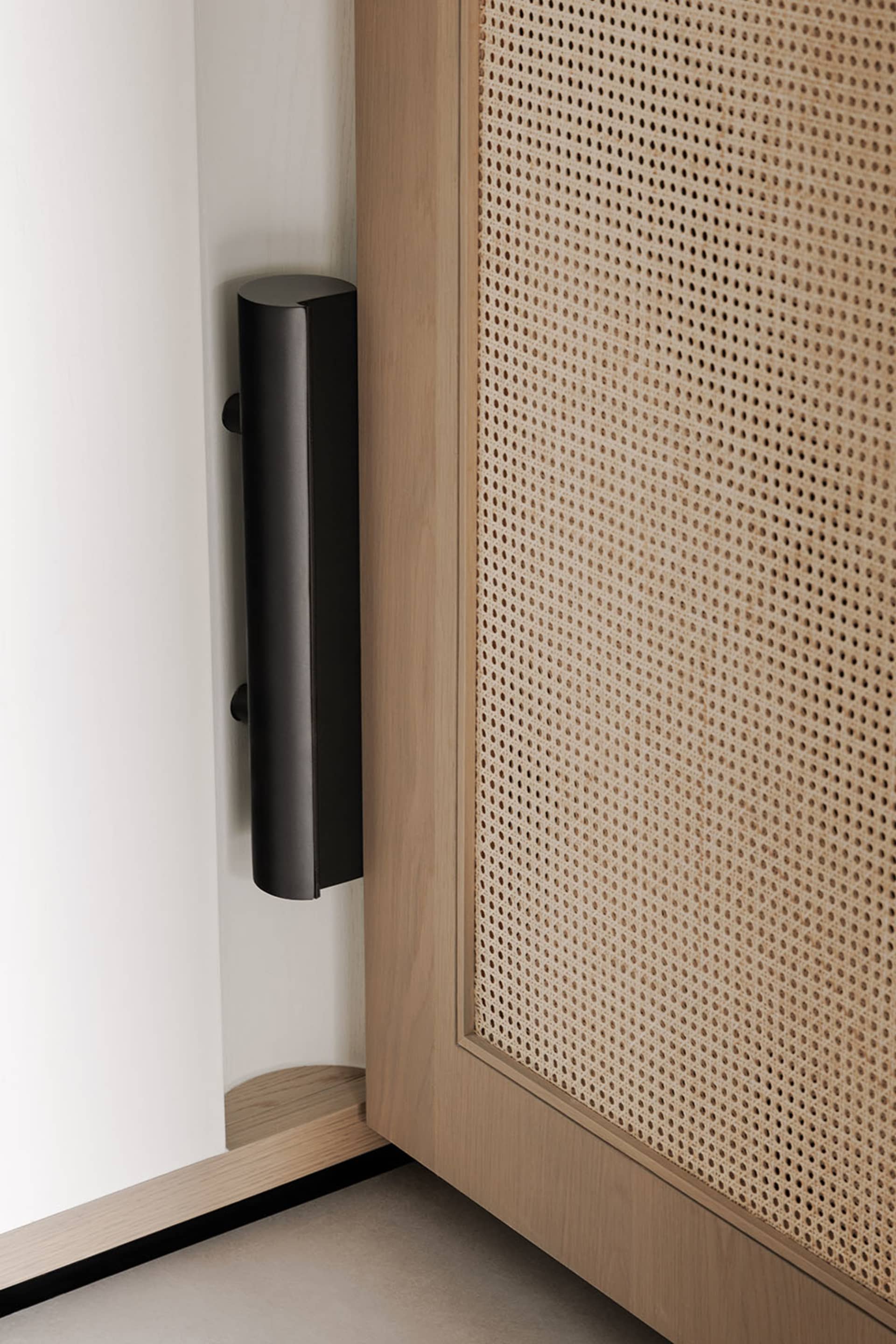Cozy living space with a wooden door, speakers, and dim lighting