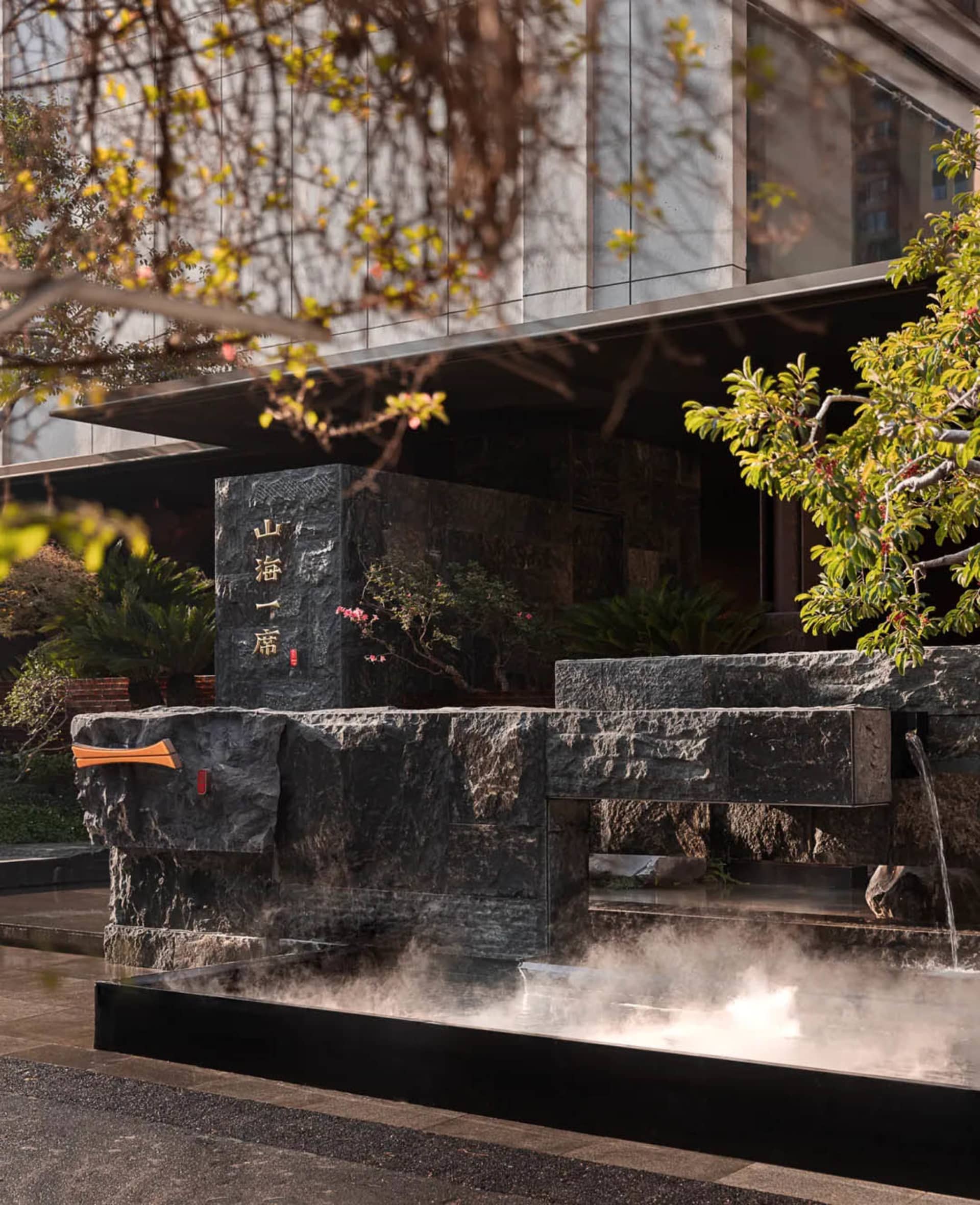 A serene stone building with a water feature in front, adding depth and visual interest